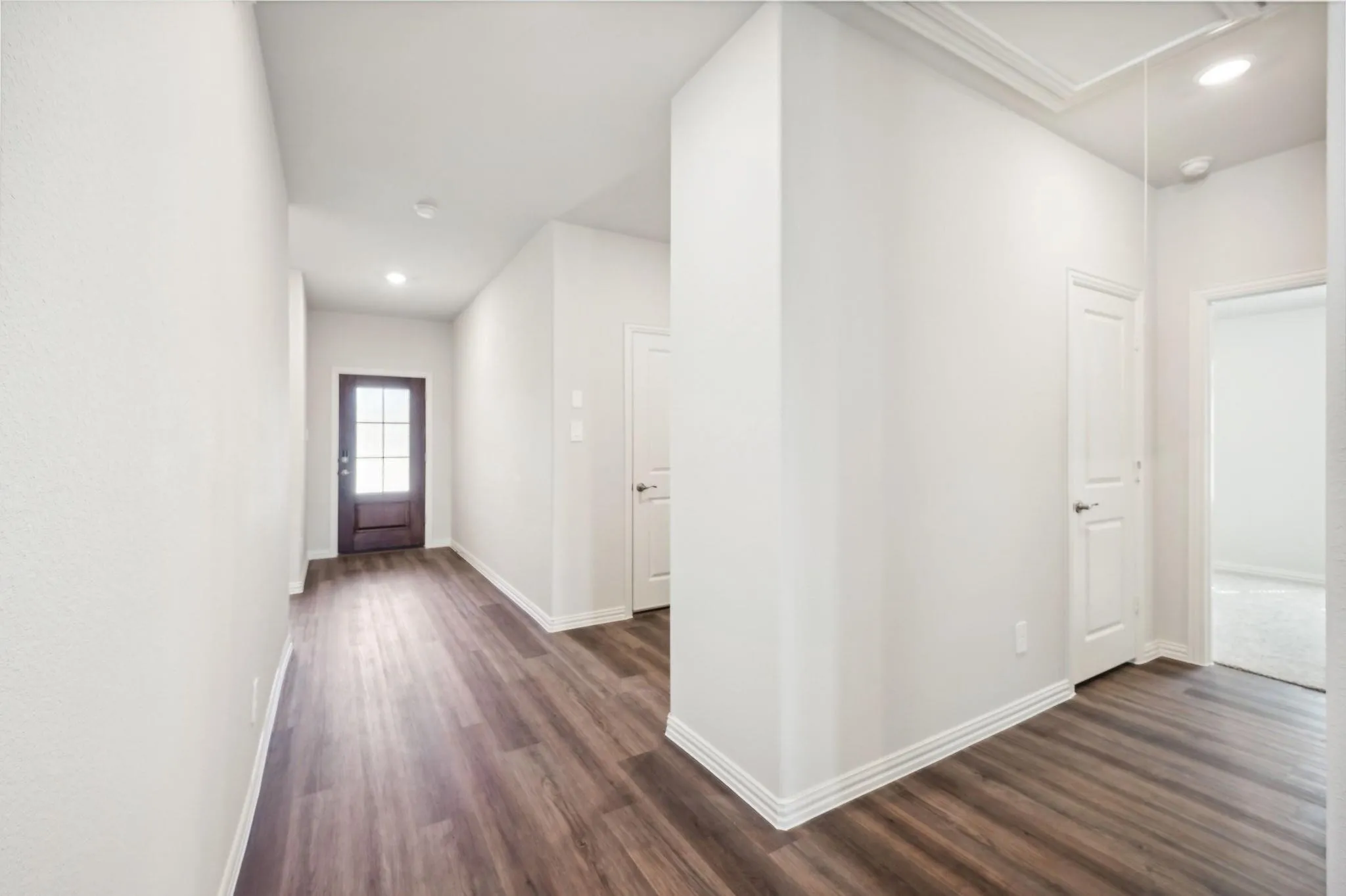 Corridor with recessed lighting, baseboards, dark wood-style floors, and attic access