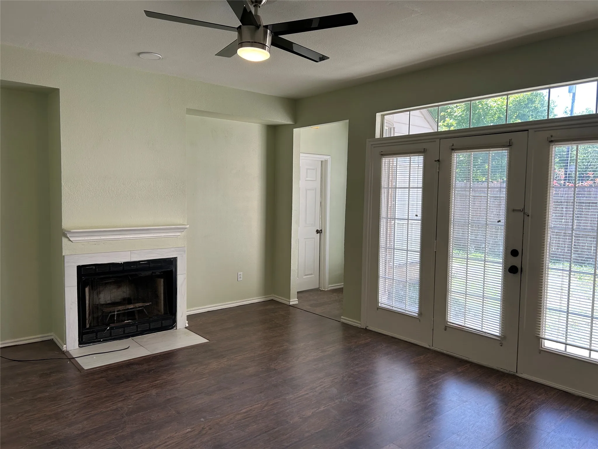 Dining area is open to living room.  Living room has French doors that open to the fenced in backyard.