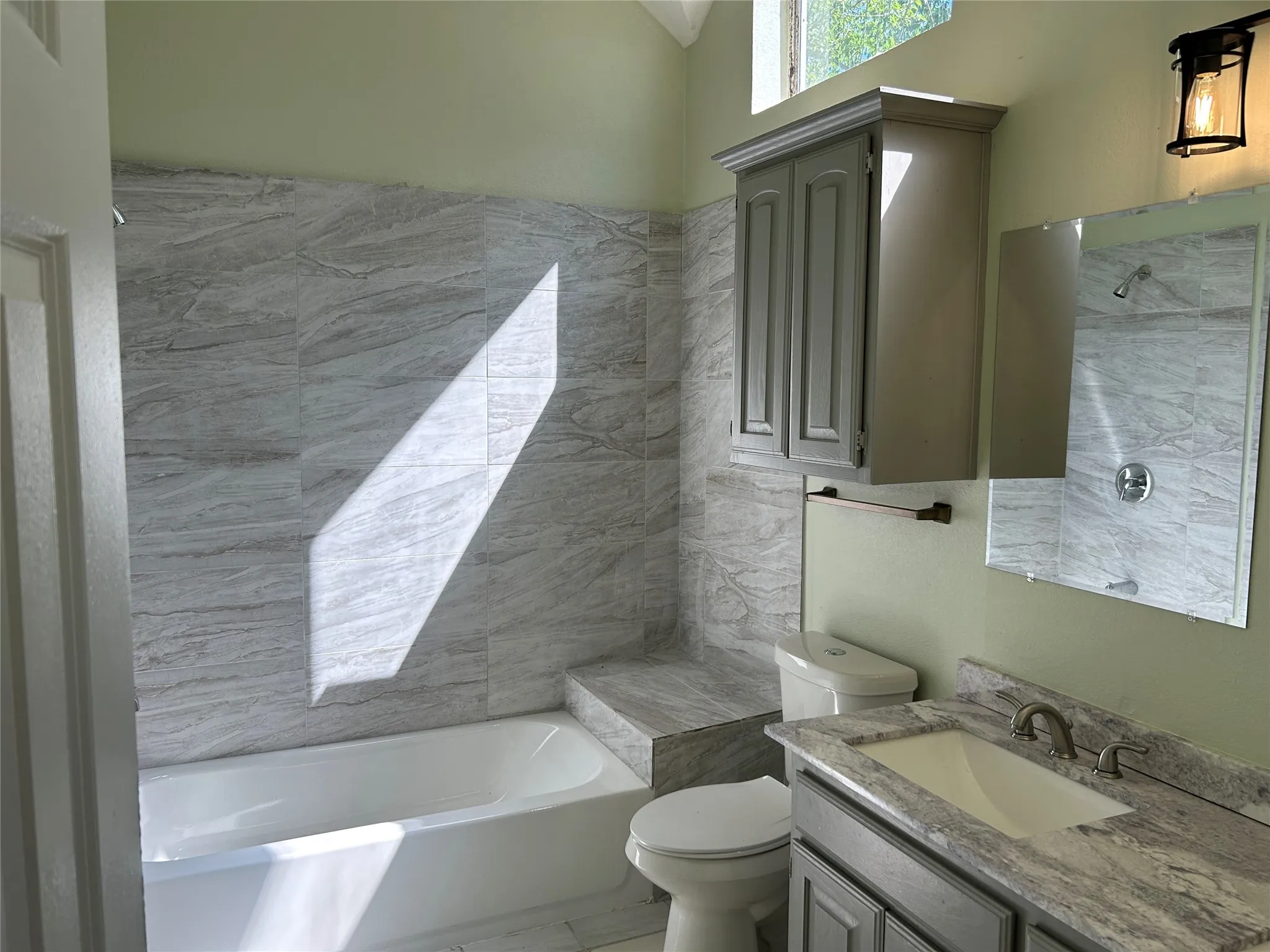 Updated primary bathroom with plenty of natural light.