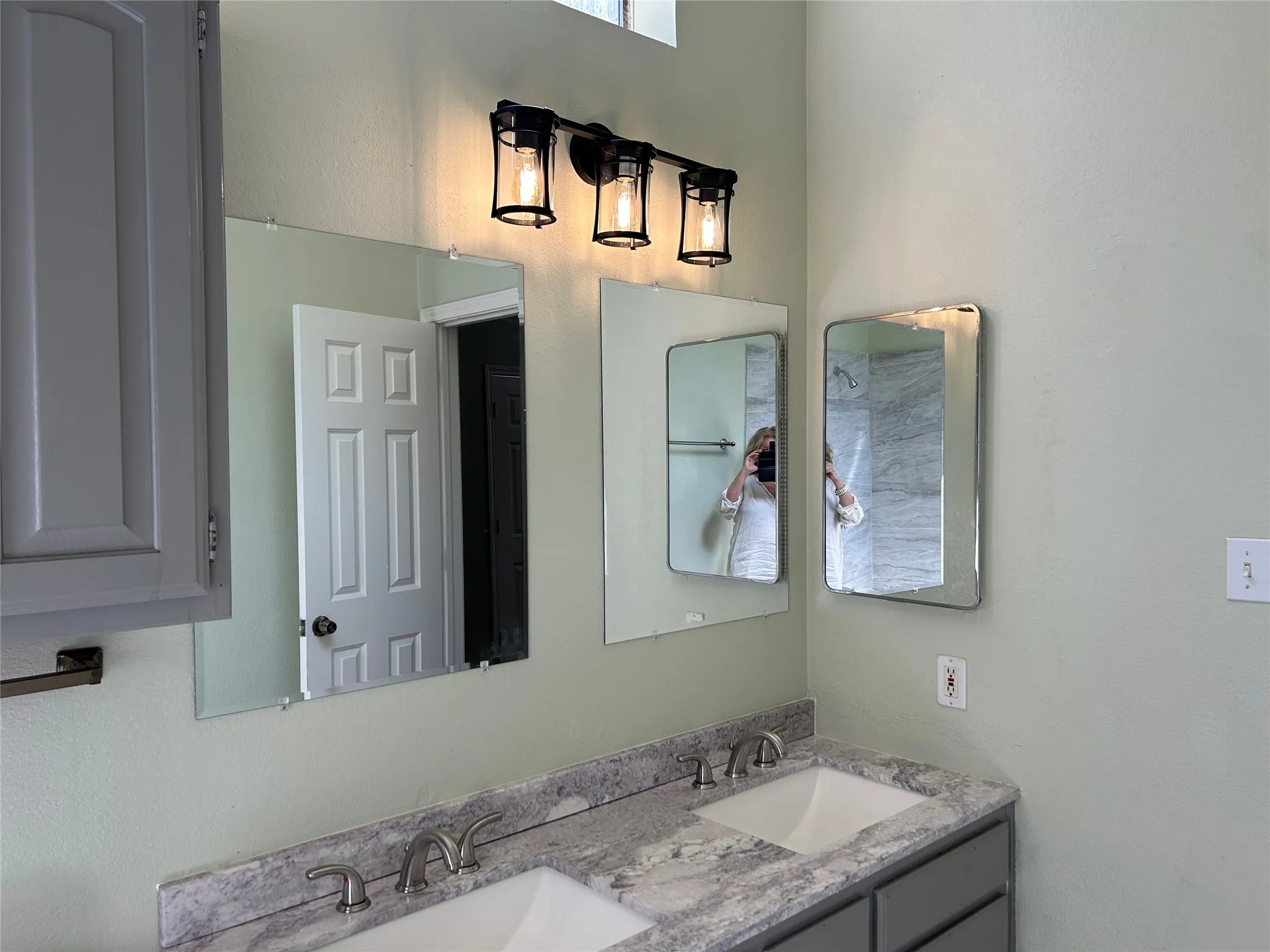 Primary bathroom with granite and dual sinks.