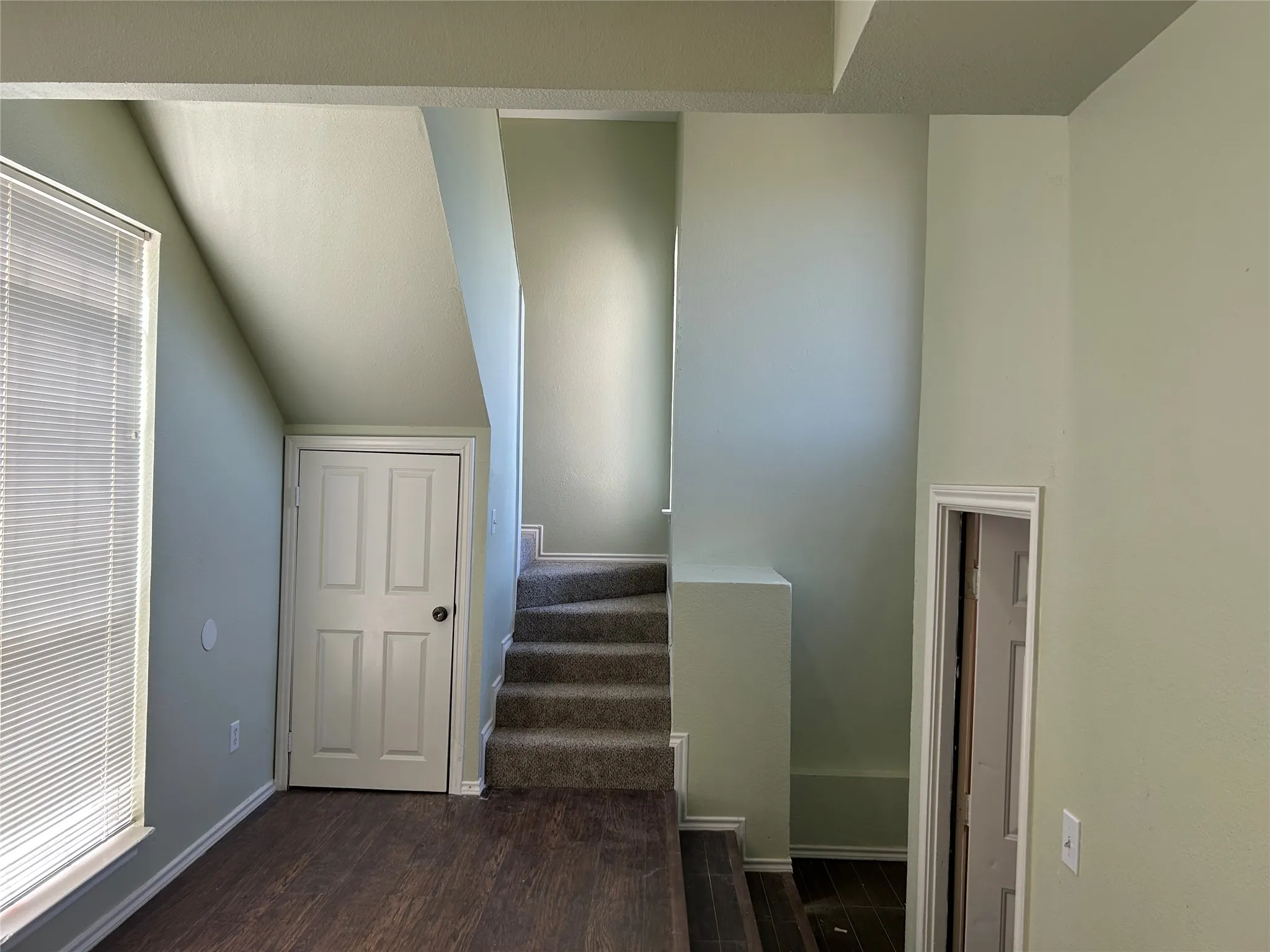 Stairs to second floor with storage closet beneath.