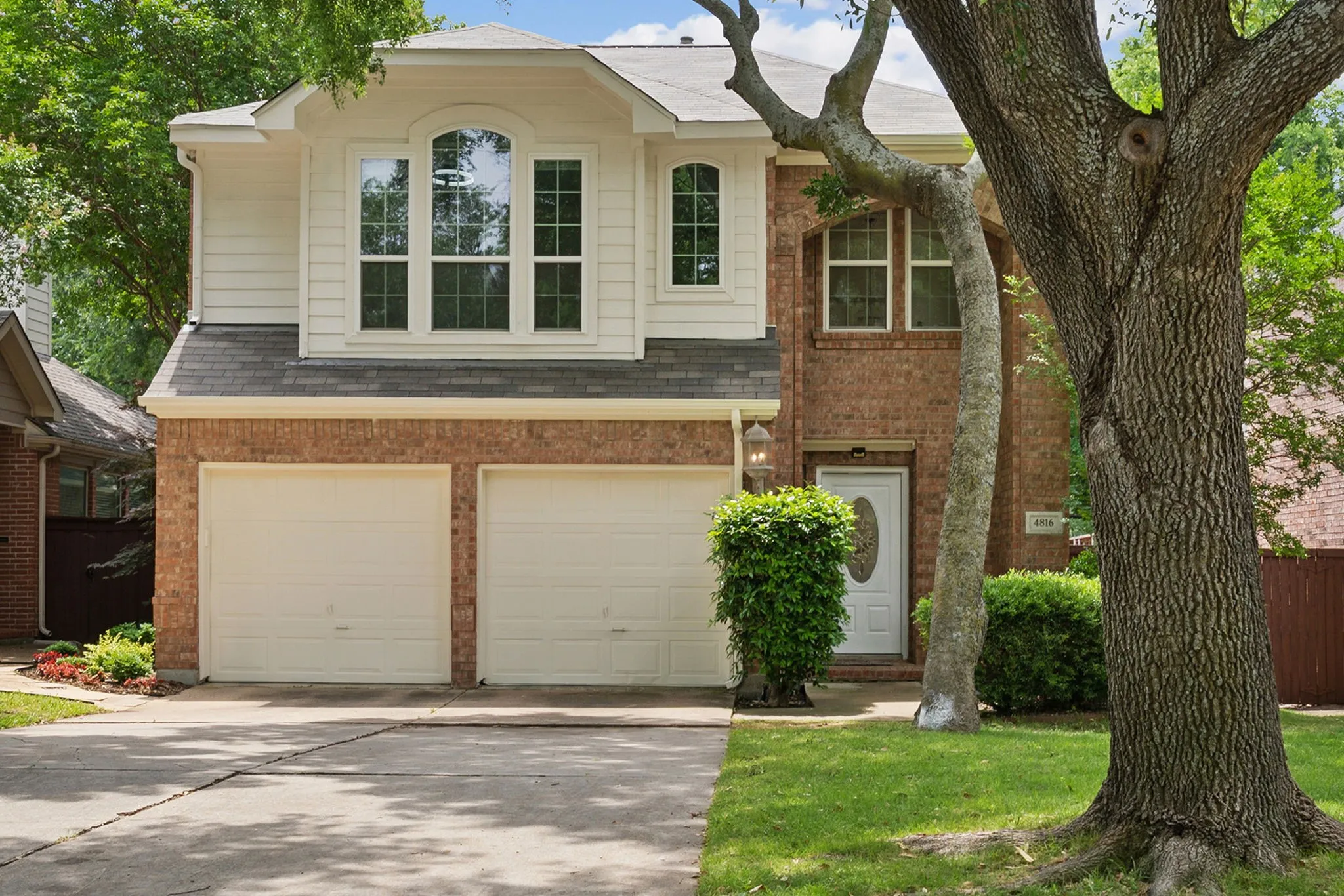 Brick and siding exterior with a two-car garage