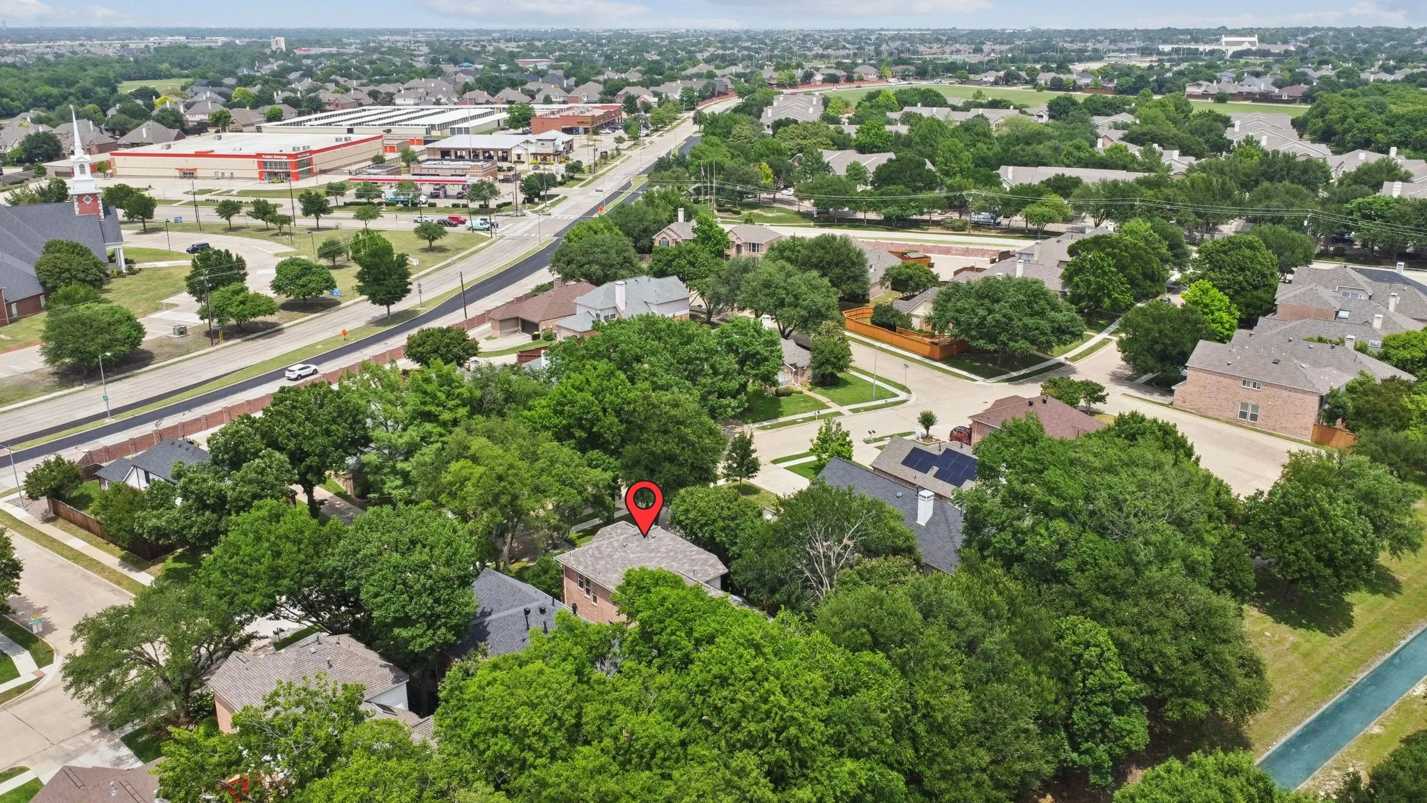 Aerial rendering showcasing the surrounding neighborhood, featuring tree-lined streets and established residential properties