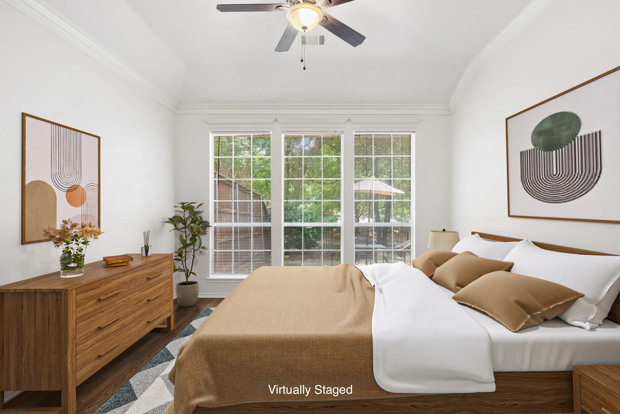 Vaulted ceilings with crown molding, ceiling fan, wood-finish flooring, and large multi-pane windows