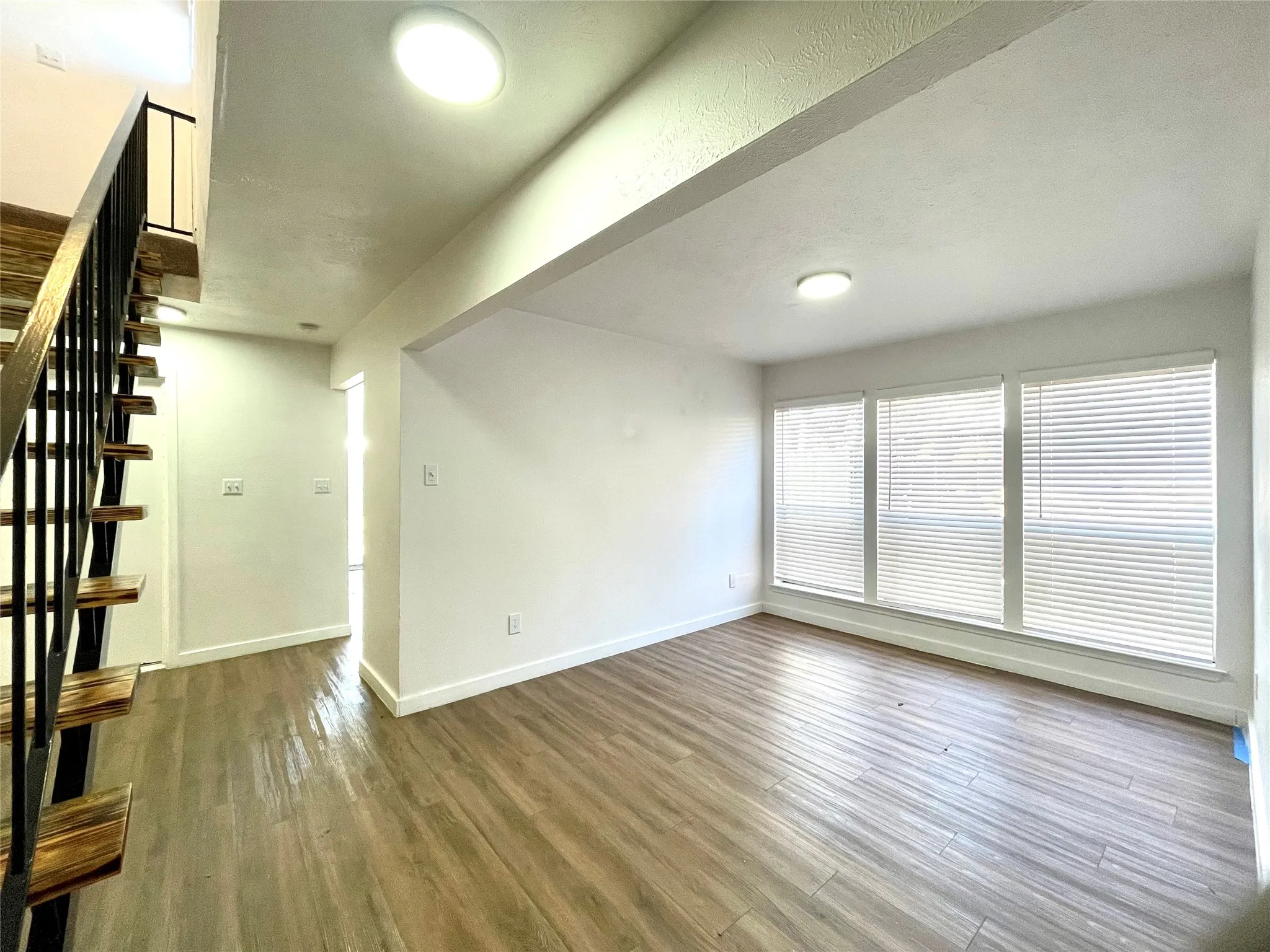 Unfurnished living room with dark hardwood / wood-style floors