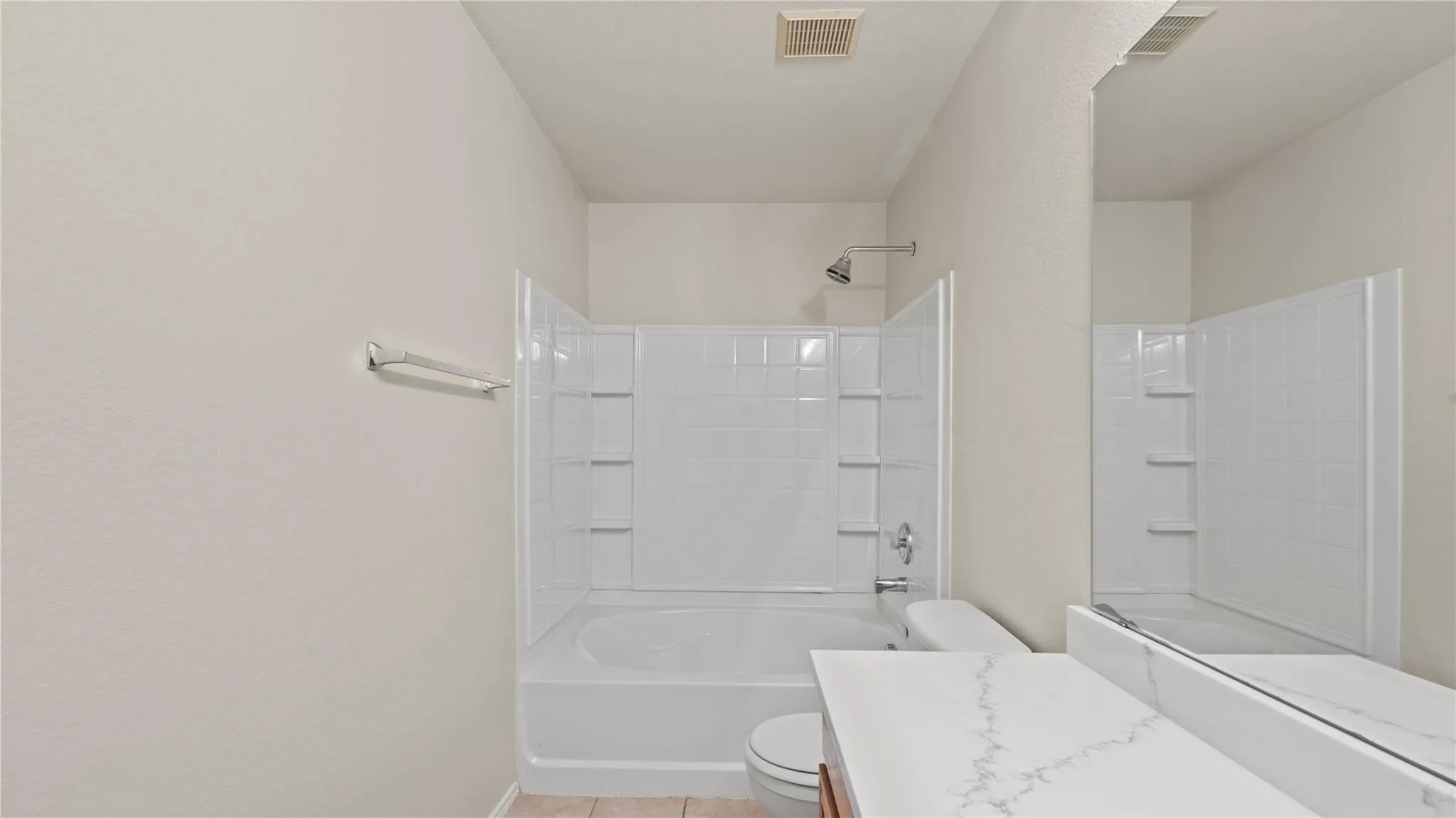 White tiled tub and shower combination with a curved shower rod