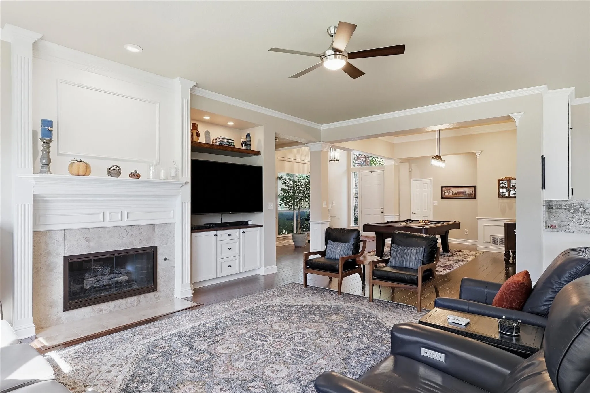 Open plan with high ceilings, hardwood floors, doublel molding mantle at the gas log FP.