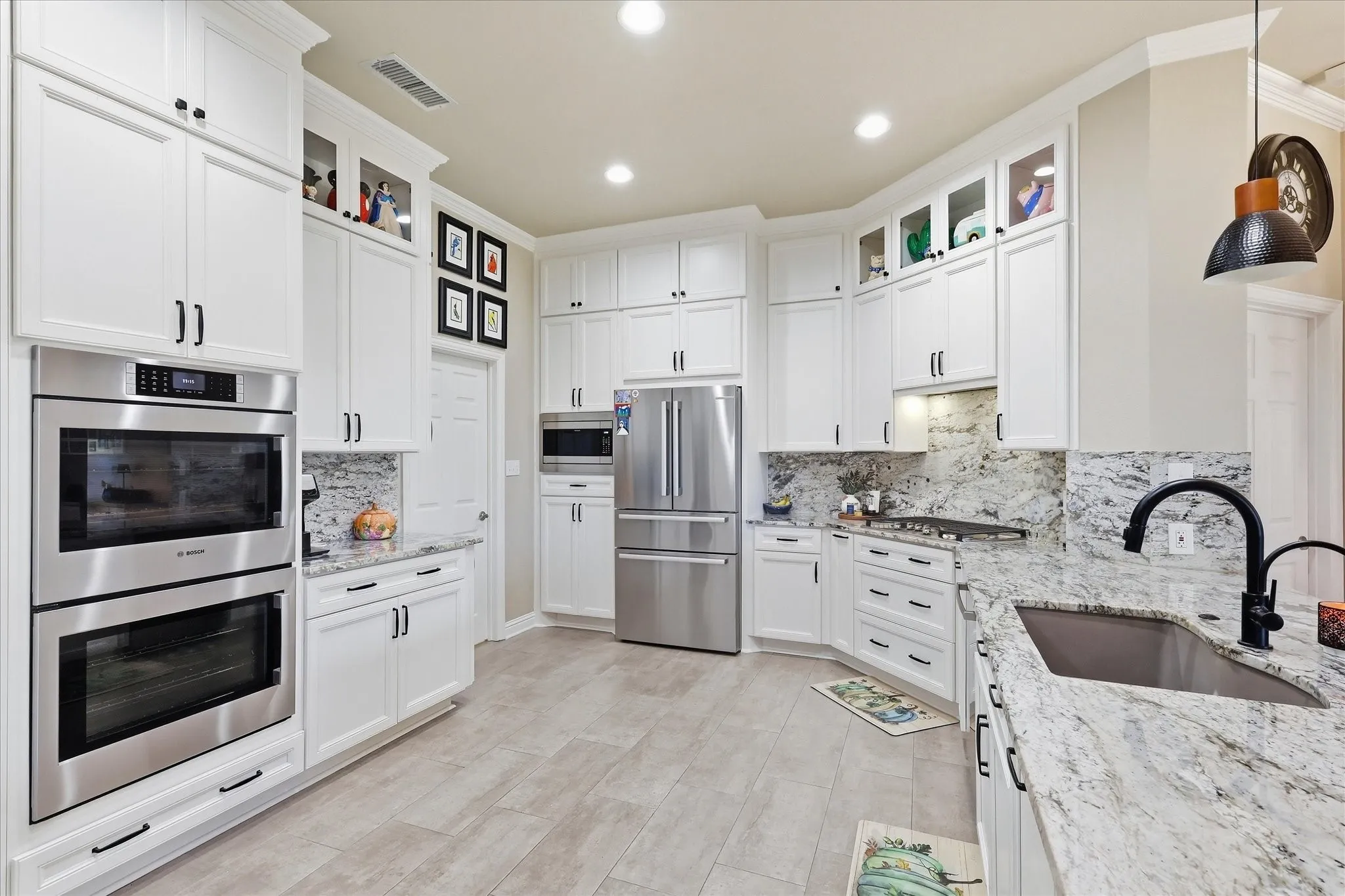 Updated kit has DBL Bosch convection oven, 5 burner gas cooktop, Granite Tops, pull out drawers, water filter & tons of cabinets.