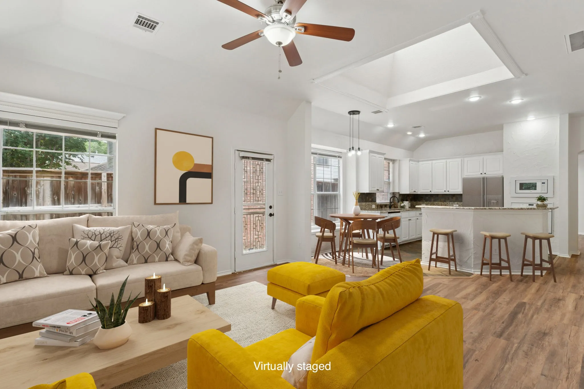 Wood-finish flooring throughout, vaulted ceiling, and a ceiling fan