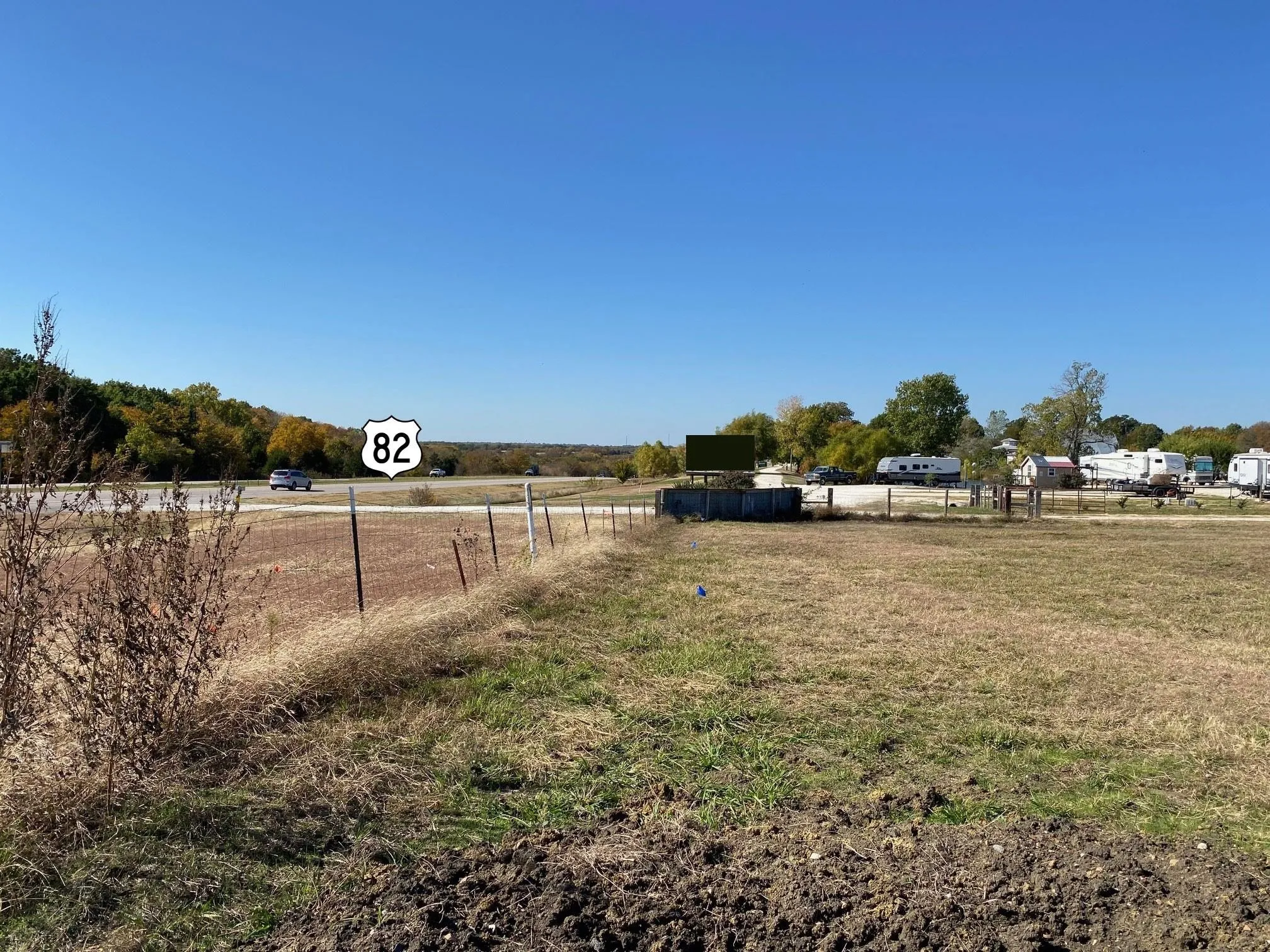 Expansive undeveloped land with a distant highway