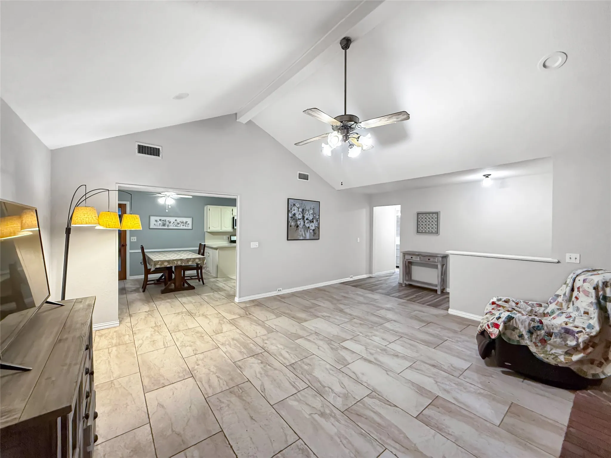Vaulted ceiling with exposed beam, ceramic tile flooring, recessed lighting, and ceiling fan