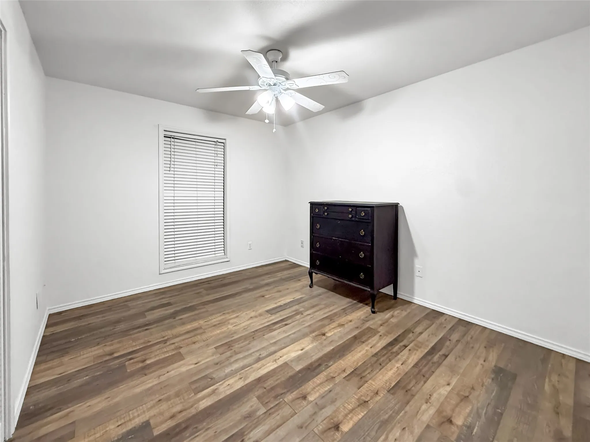 Wood-finish flooring with crisp white walls and ceiling