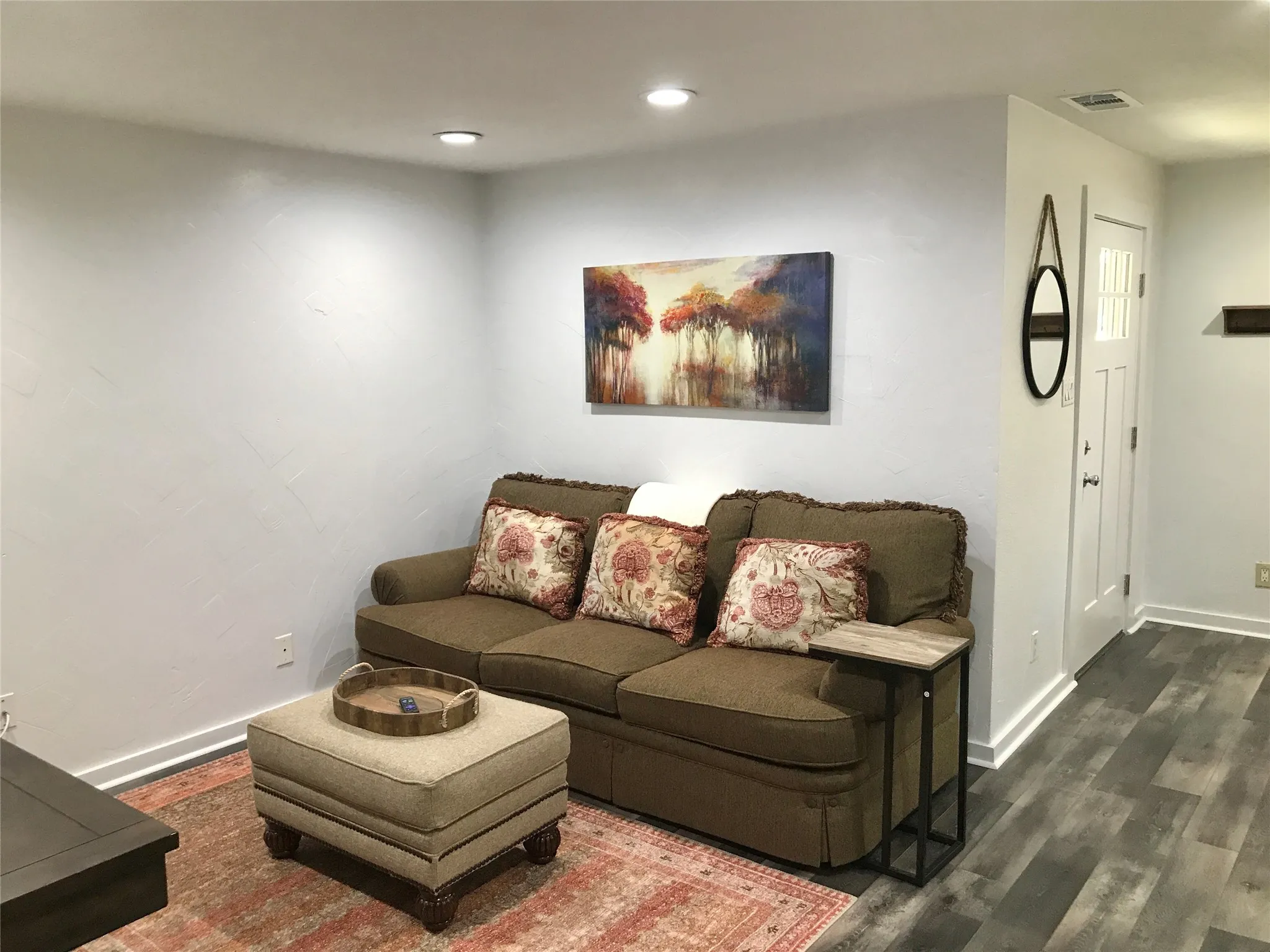 Recessed ceiling lighting illuminates the space, complemented by light-toned wall finishes
