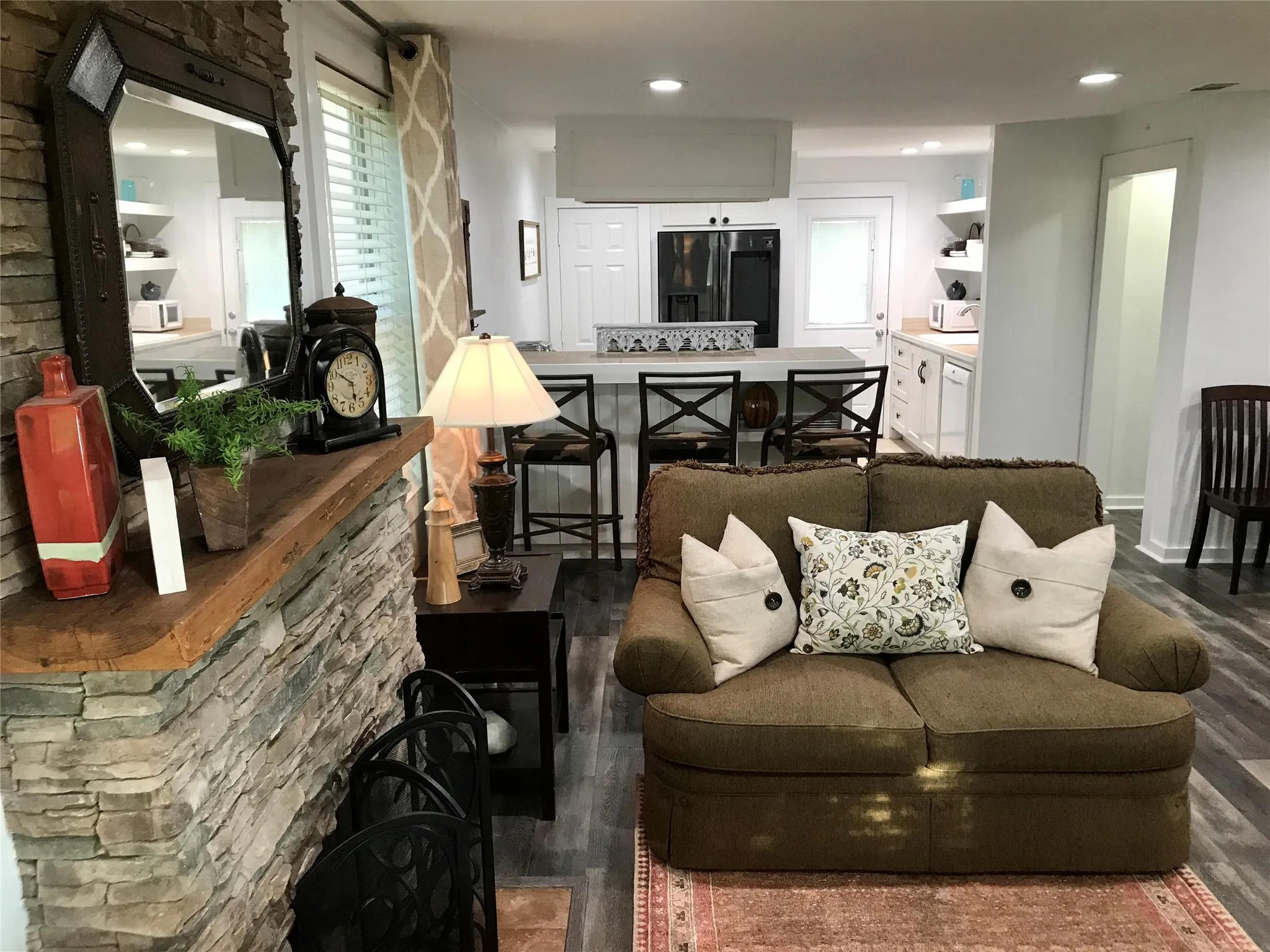 Stone veneer fireplace with a wood mantel