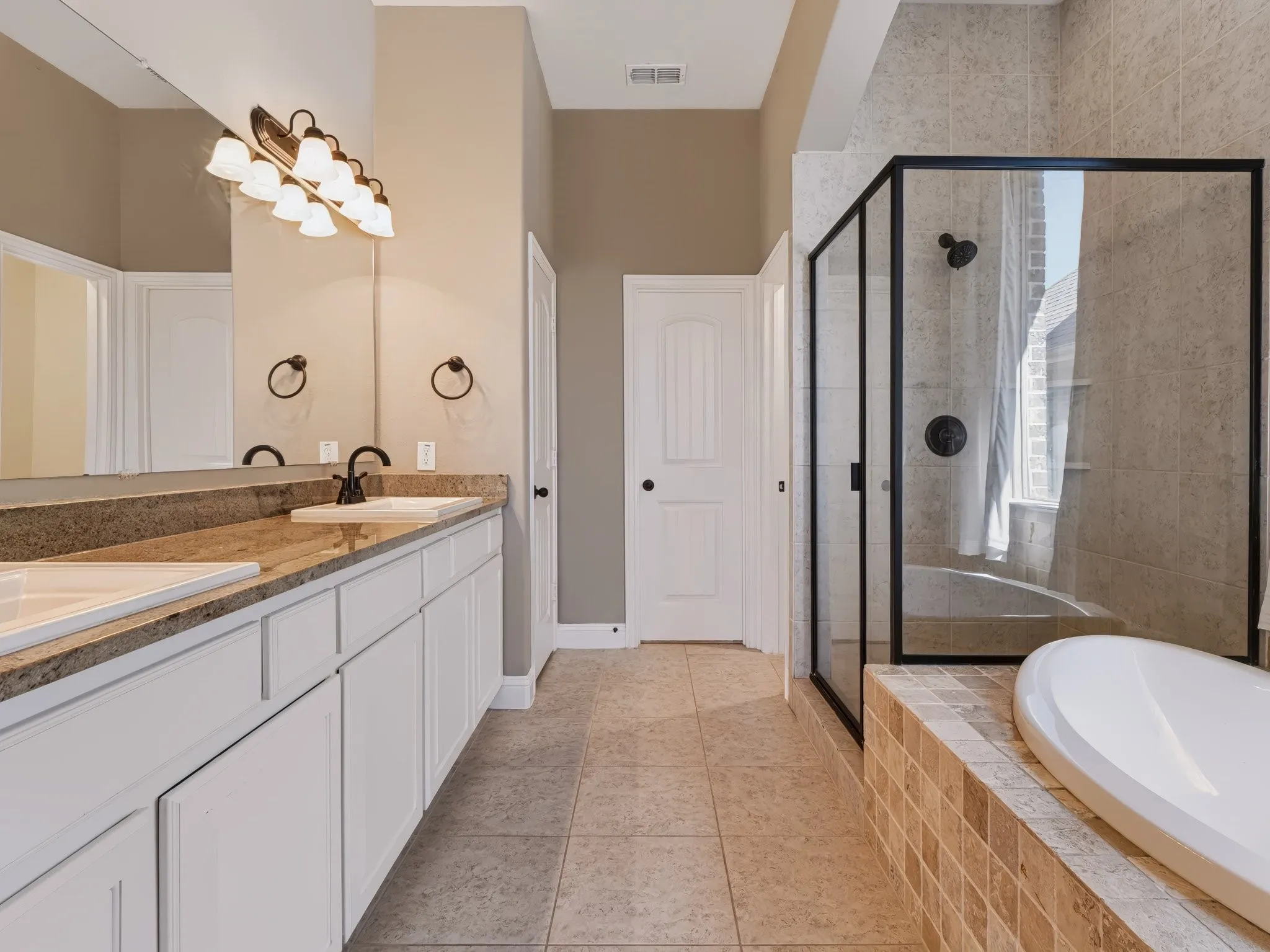 Dual vanity with undermount sinks and dark bronze fixtures