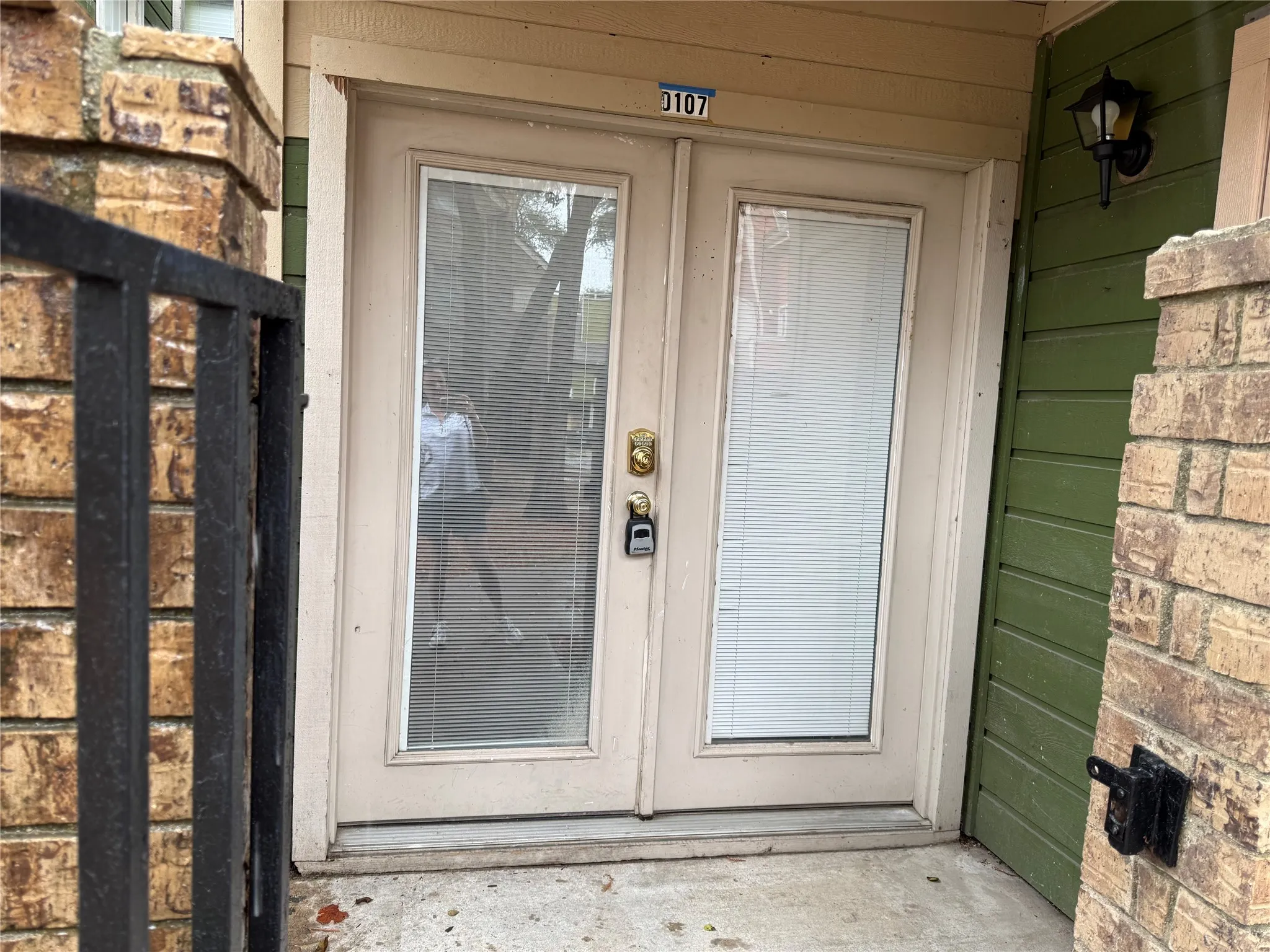 Gated covered front Patio with storage closet