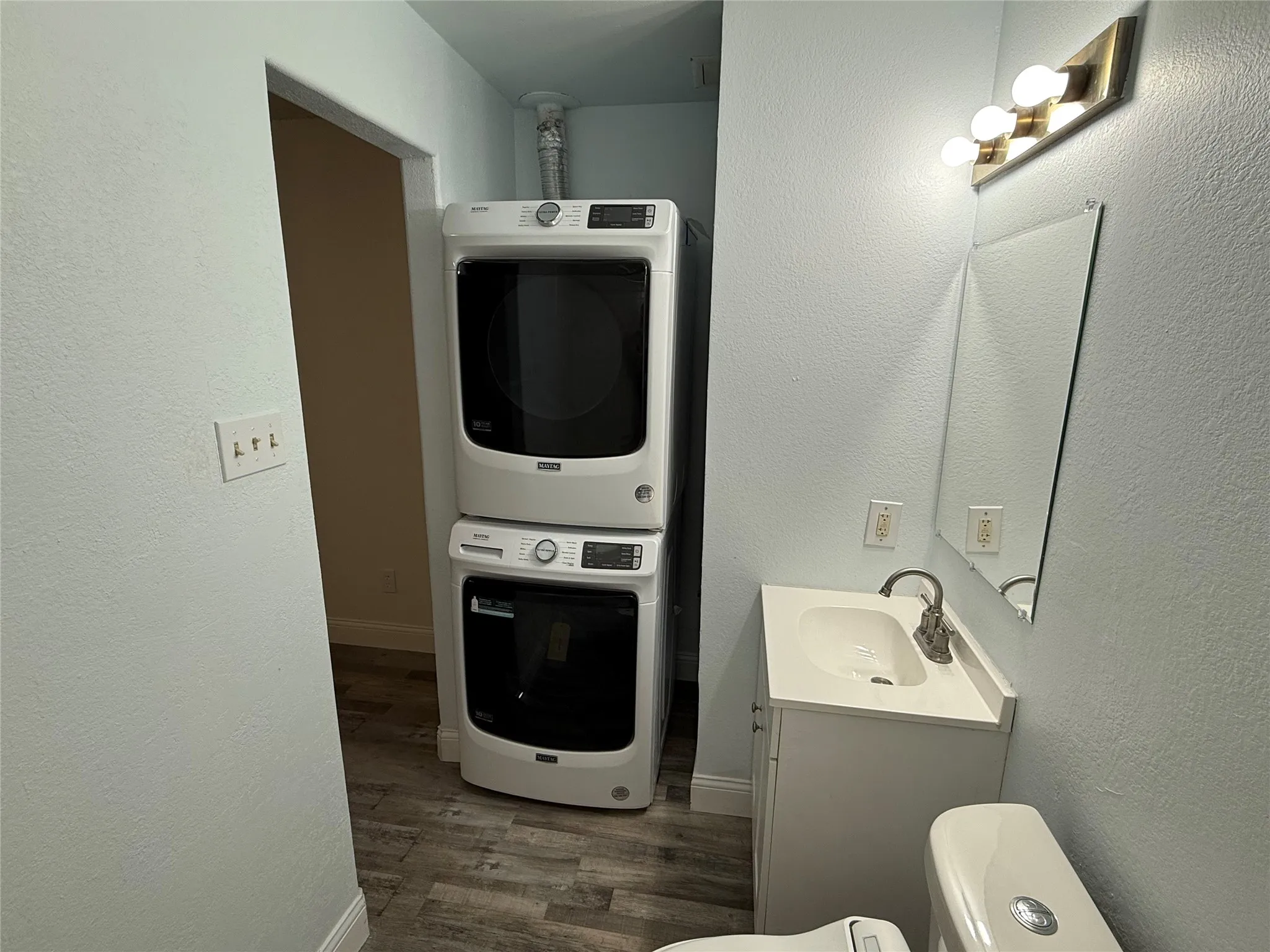 Full Size 2024 Maytag stackable Washer and Dryer located in full bath.