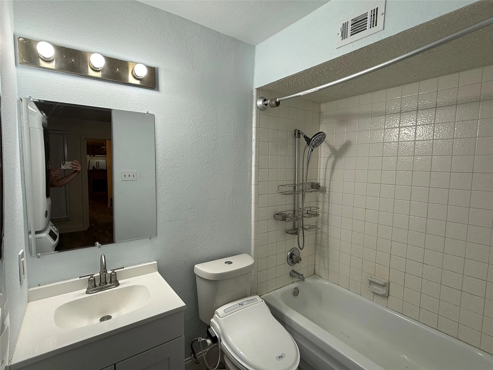 Bathroom with tub shower and vanity.