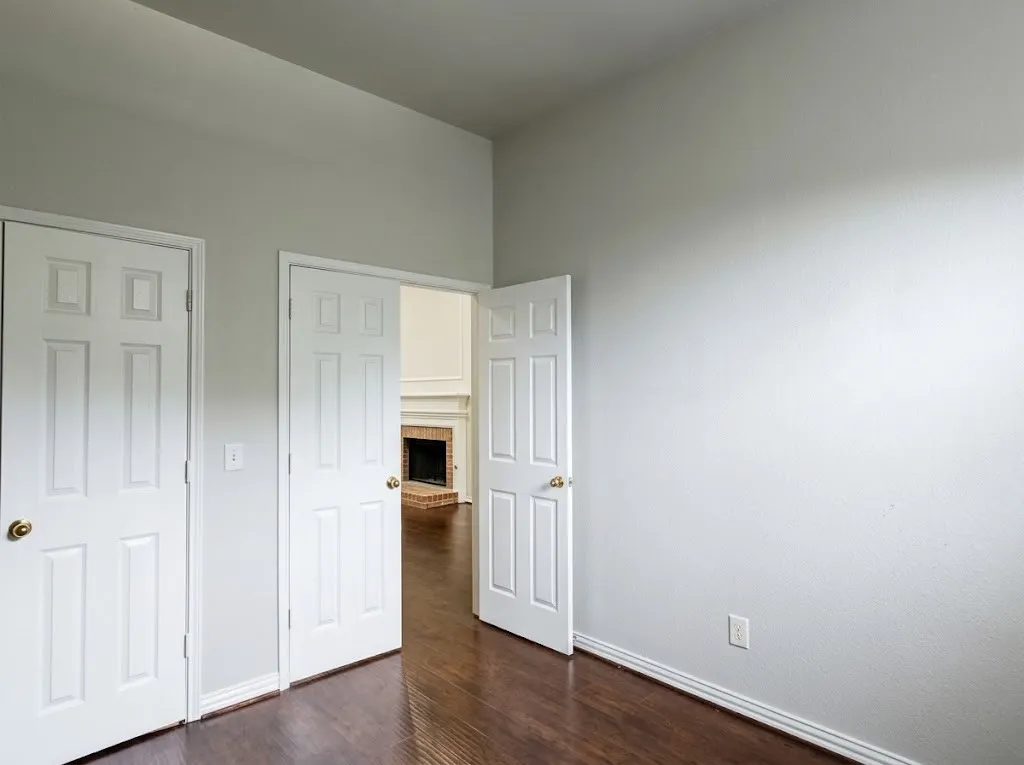 Wood-finish flooring throughout, white paneled doors, and light-toned walls