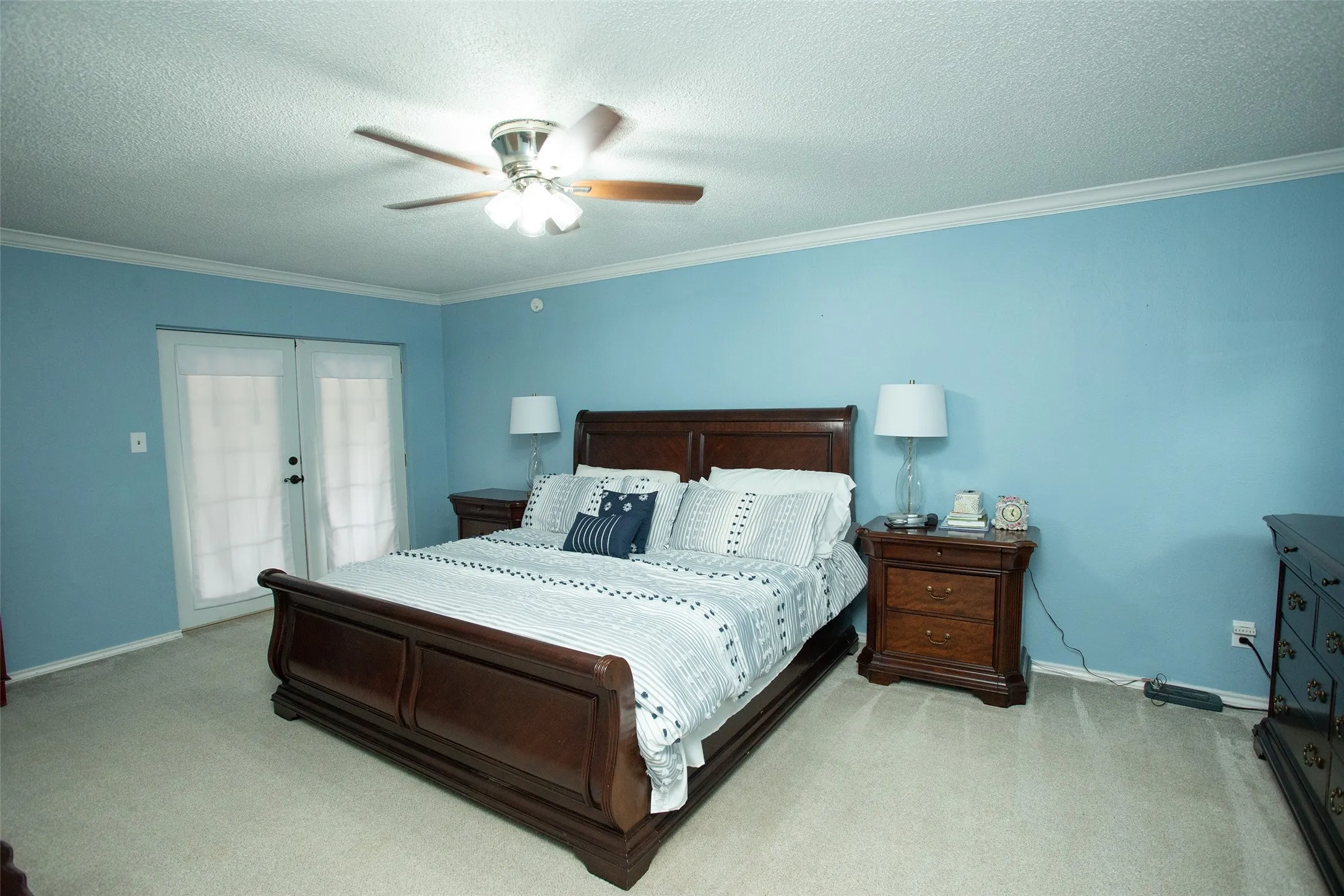 French doors with privacy shades, crown molding, and a ceiling fan with integrated lighting