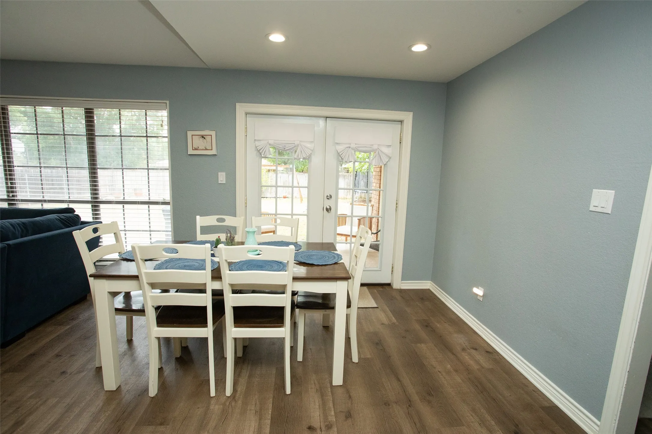 Wood-finish flooring, recessed lighting, and a window with blinds