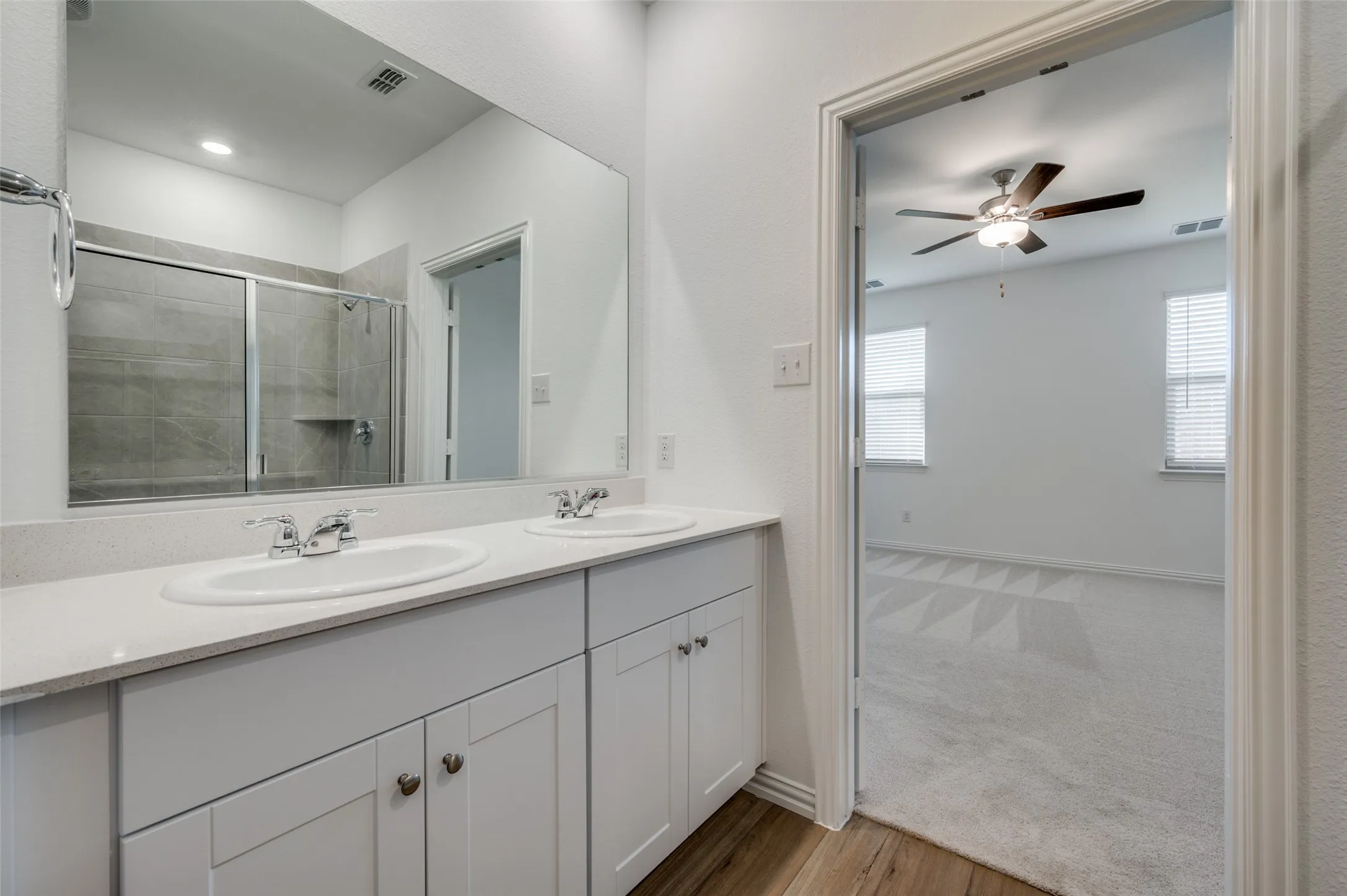 Dual vanity with white cabinetry and chrome fixtures