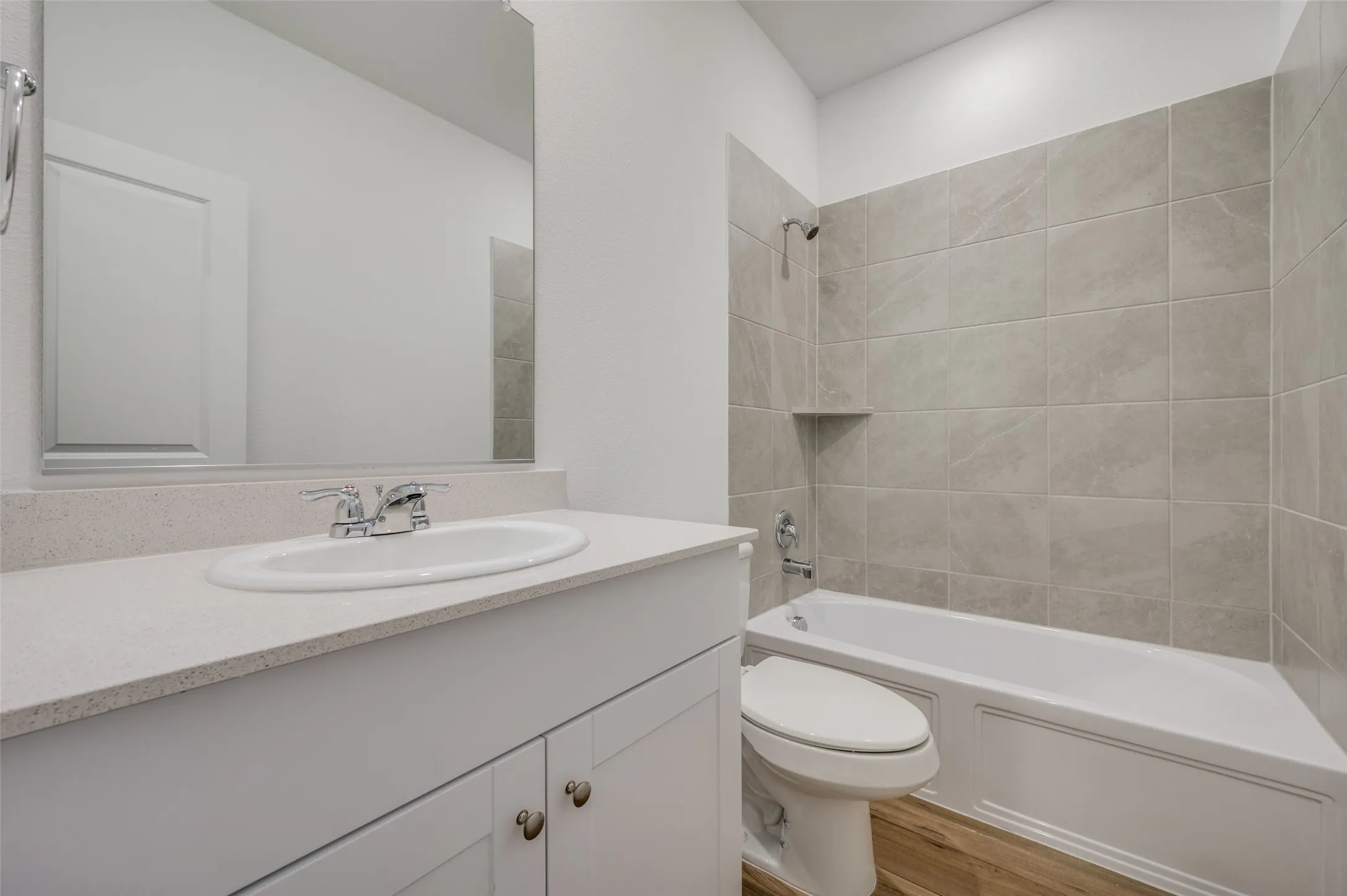 White vanity with an integrated sink and light-toned countertop