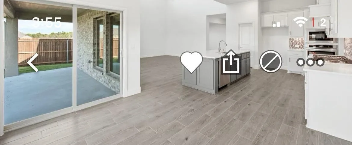 Kitchen featuring stainless steel appliances, light wood-style flooring, light countertops, white cabinets, and a center island with sink