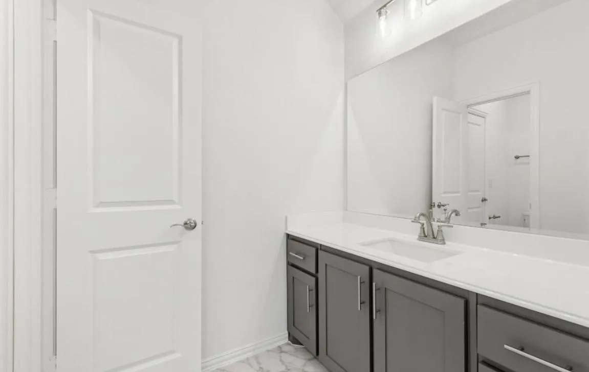 Bathroom with vanity and marble finish floors