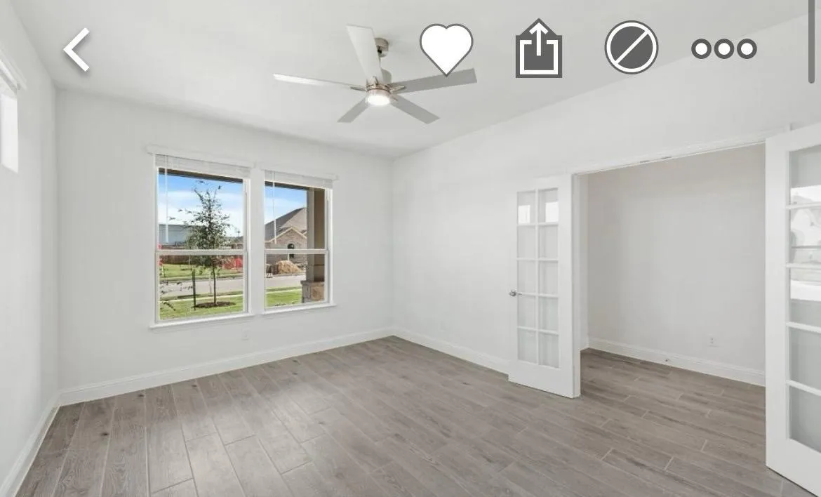 Unfurnished bedroom featuring wood finished floors and a ceiling fan