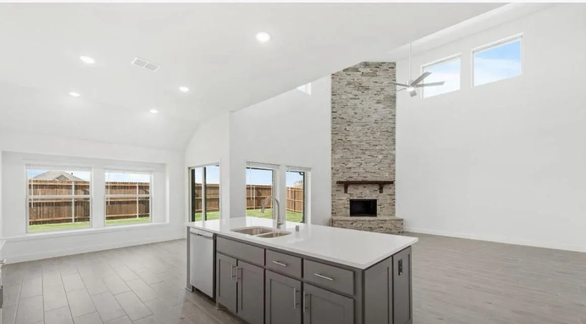 Kitchen with open floor plan, white dishwasher, gray cabinets, wood finished floors, and recessed lighting