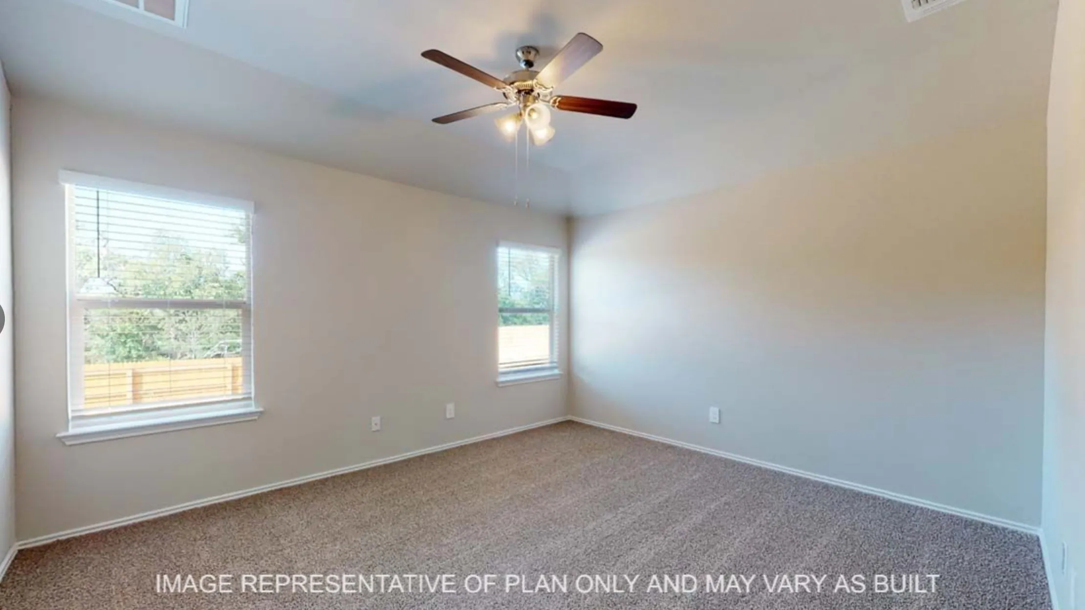 Carpeted flooring, vaulted ceiling, two windows, and a ceiling fan with integrated lighting