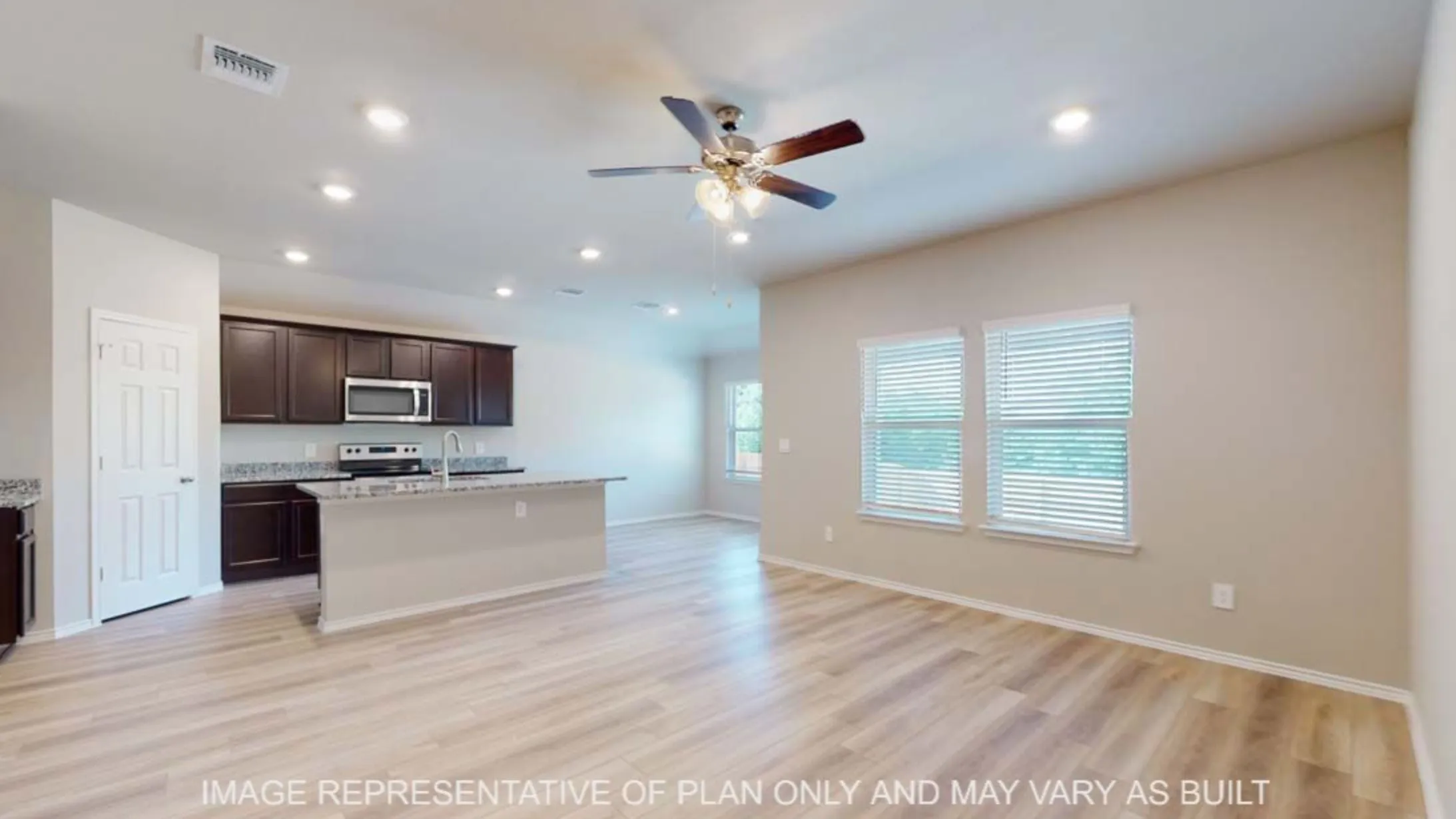 Open-concept living space featuring wood-finish flooring, recessed lighting, and a ceiling fan