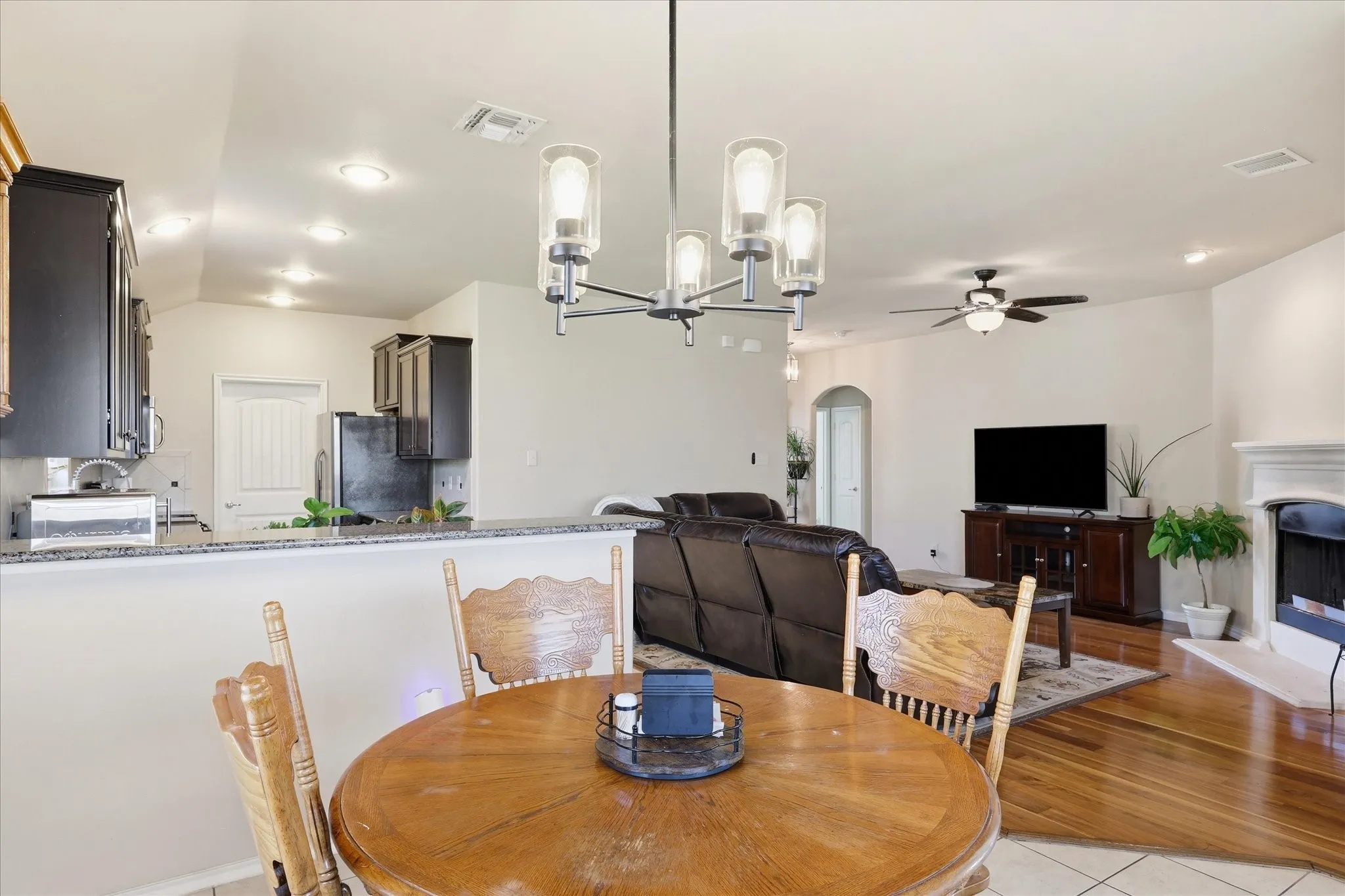 View to show this great layout. The tall ceilings make the home feel bigger and elegant. Updated fixtures and ceiling fans.  Enjoy the fireplace on cold morning from comfort of the table.