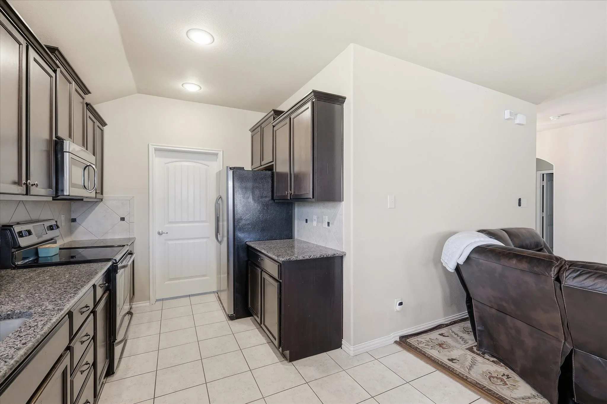With tile floors floor easy clean up of kids spills and to maintain.  Door to upper center past refrigerator is the utility laundry room.