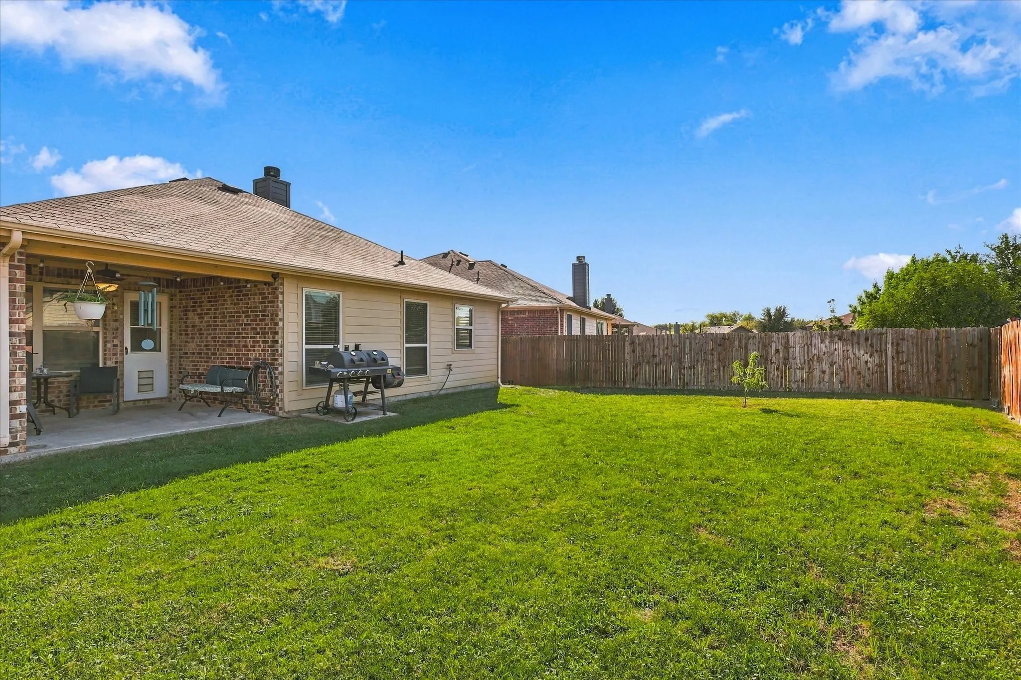 One of the few homes for sale with a covered back patio. HUGE flat yard to actually be able to use.
gutters included.