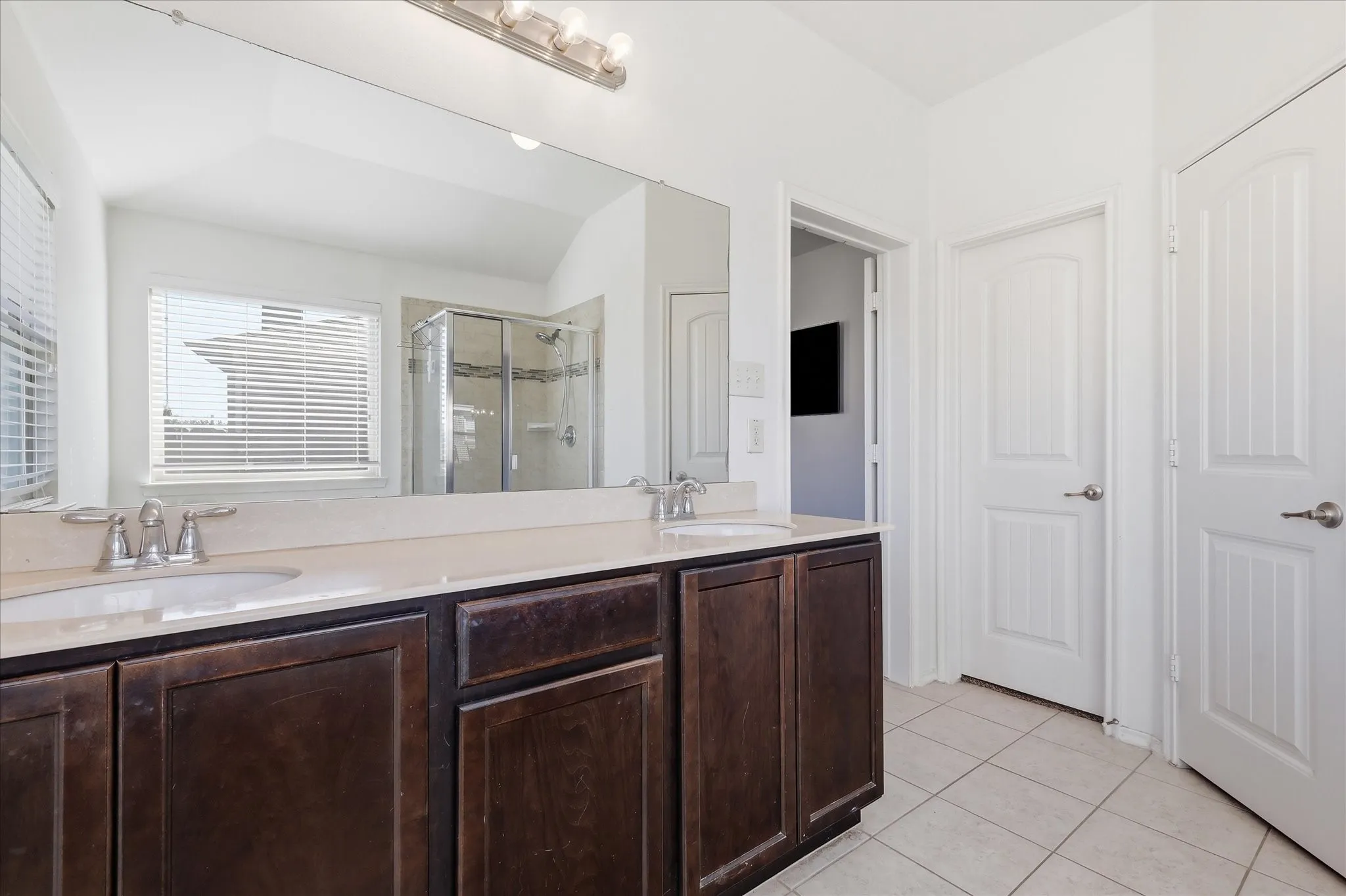 Primary bath with dual vanity and large mirror something we hear buyers love.  Walk in closets and the must have door on latrine!