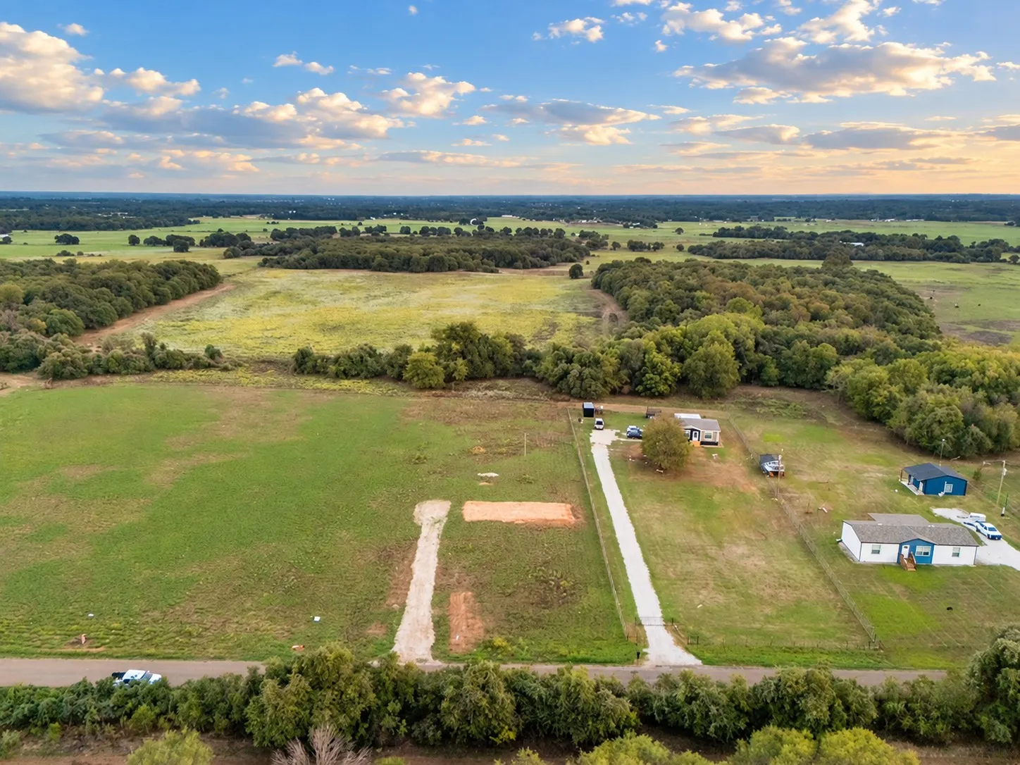 Expansive green landscape with scattered trees