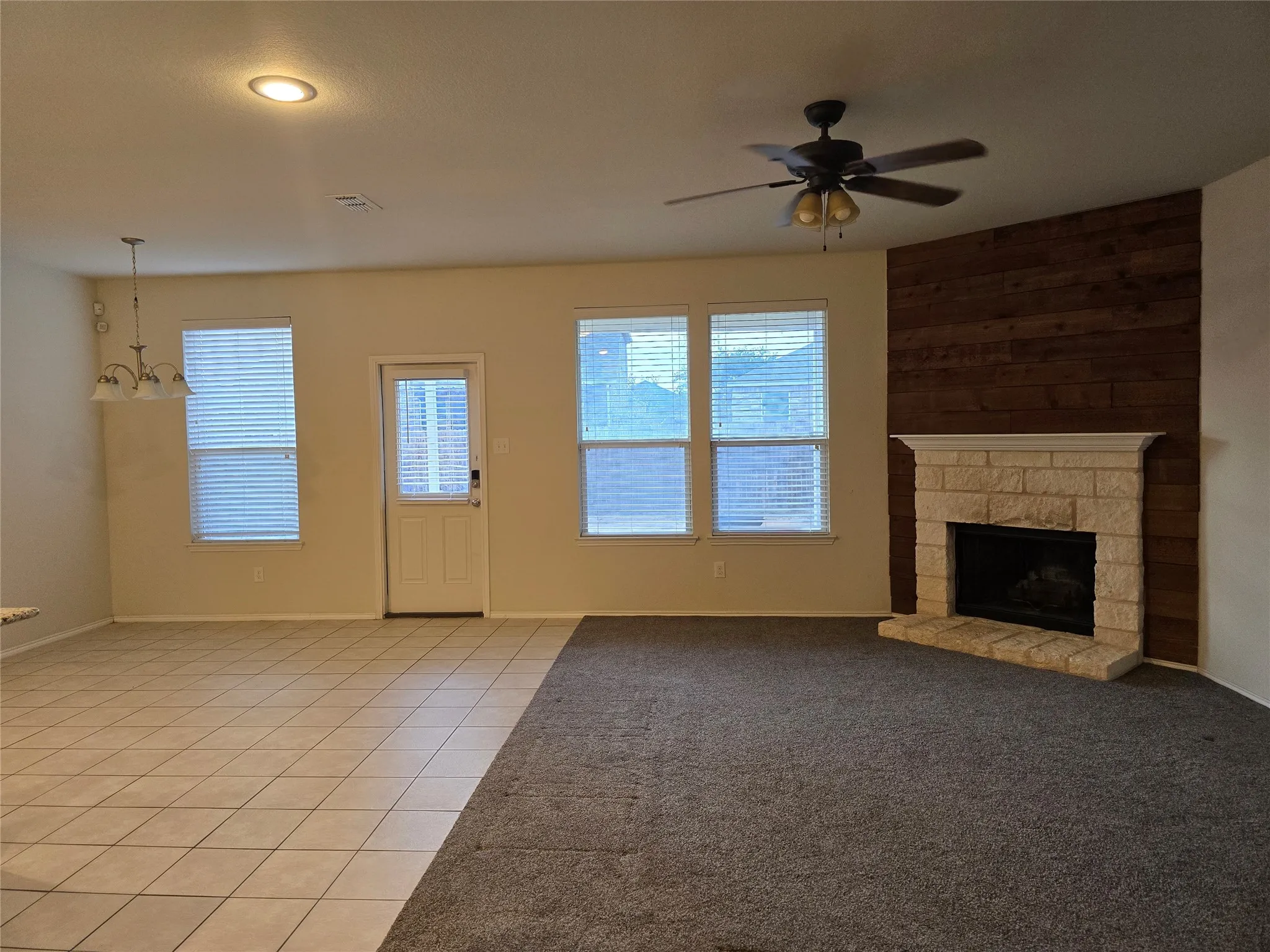 Stone-faced fireplace with a wood-plank accent wall