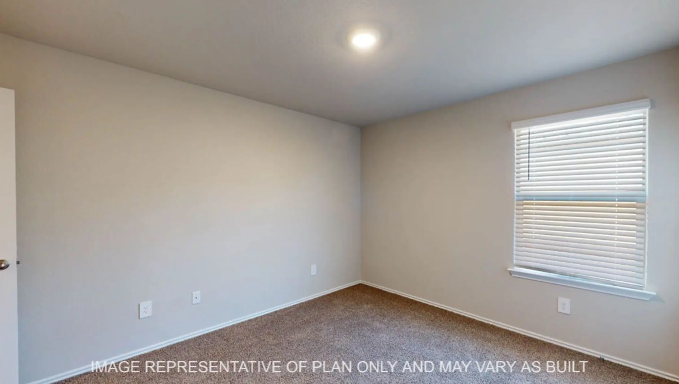 Neutral wall paint, recessed ceiling lighting, textured carpet flooring, and a single window with blinds