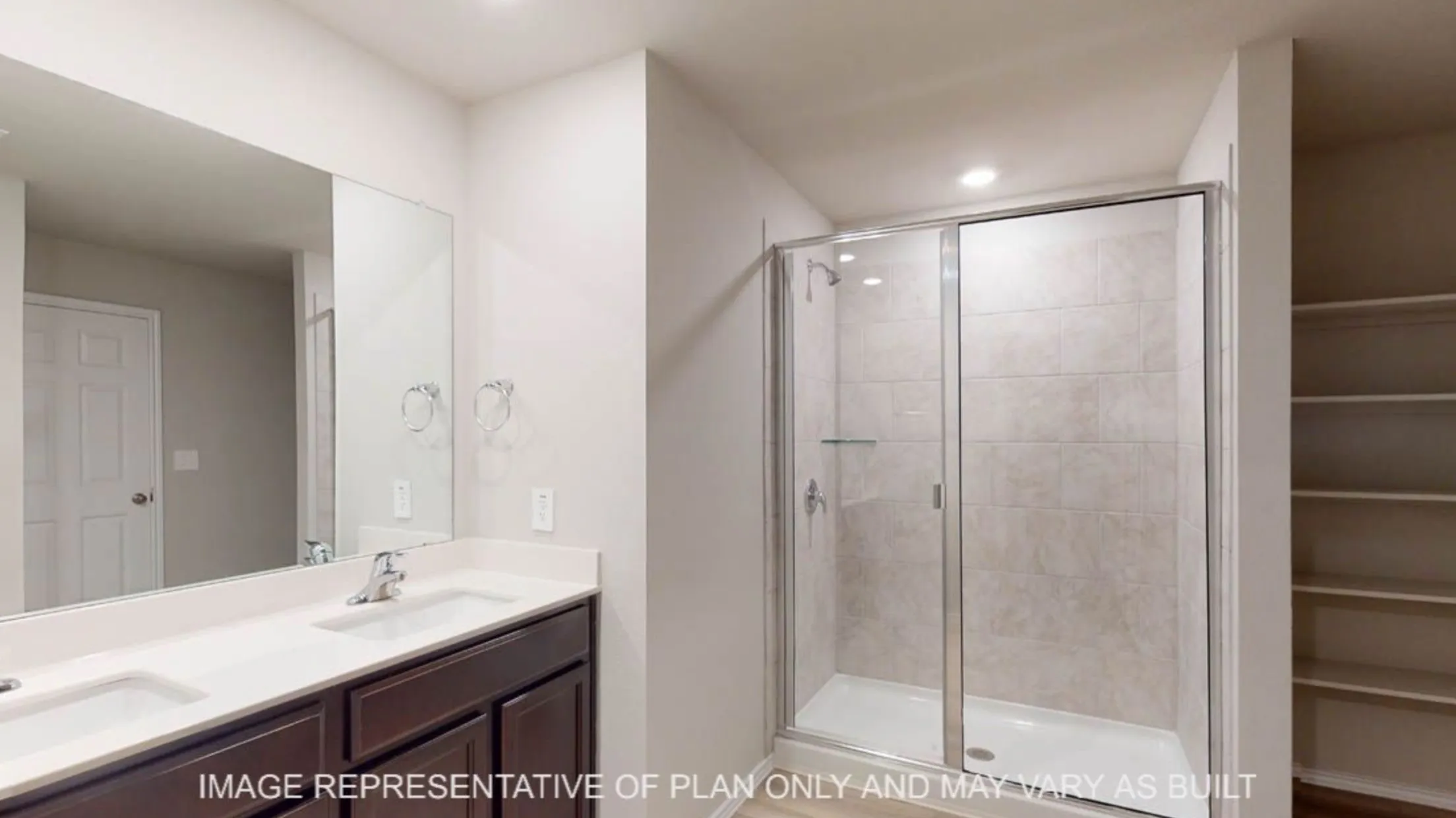 Double vanity with undermount sinks and dark wood cabinetry