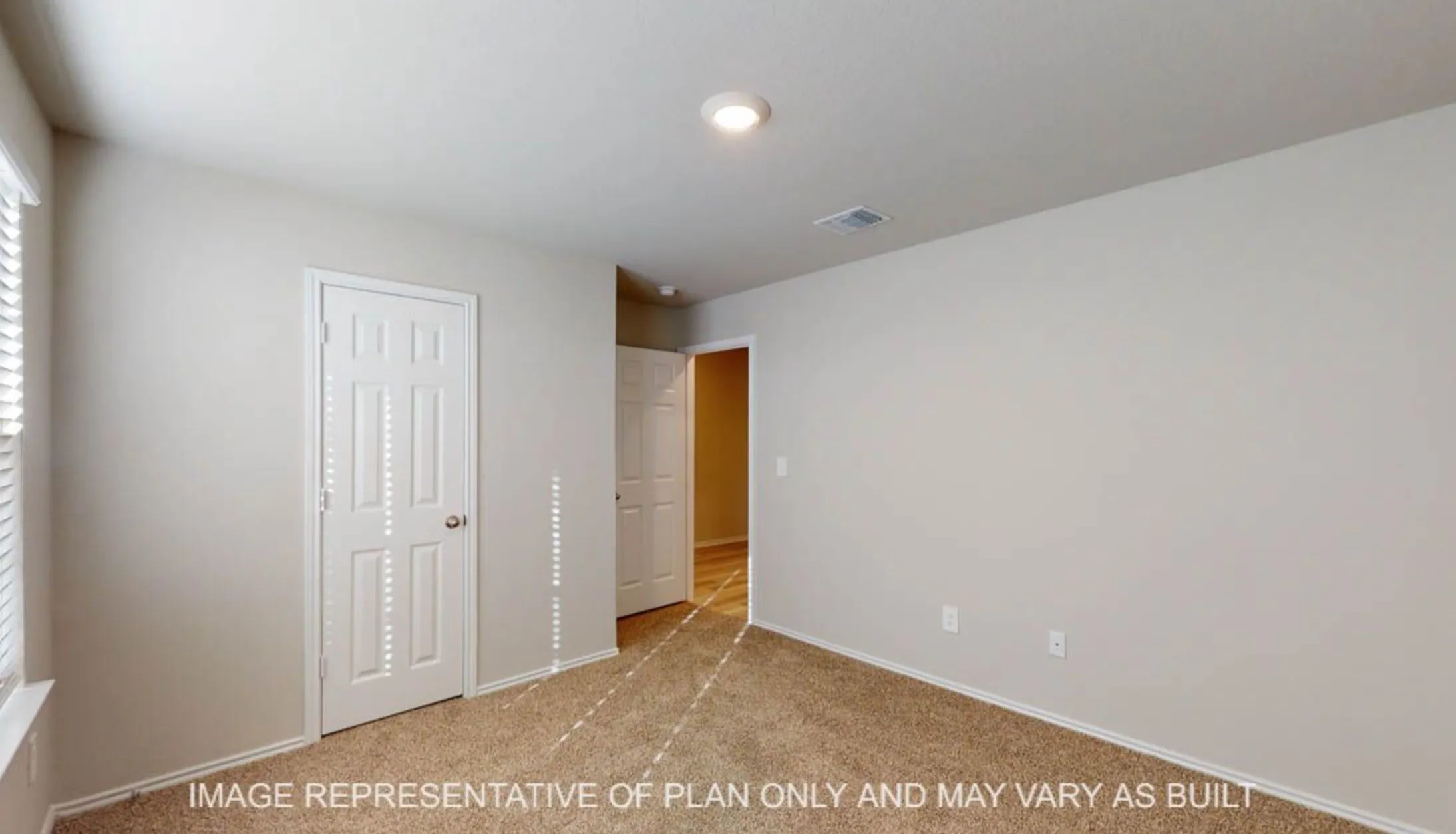 Neutral wall paint, carpet flooring, a single window with blinds, and recessed lighting