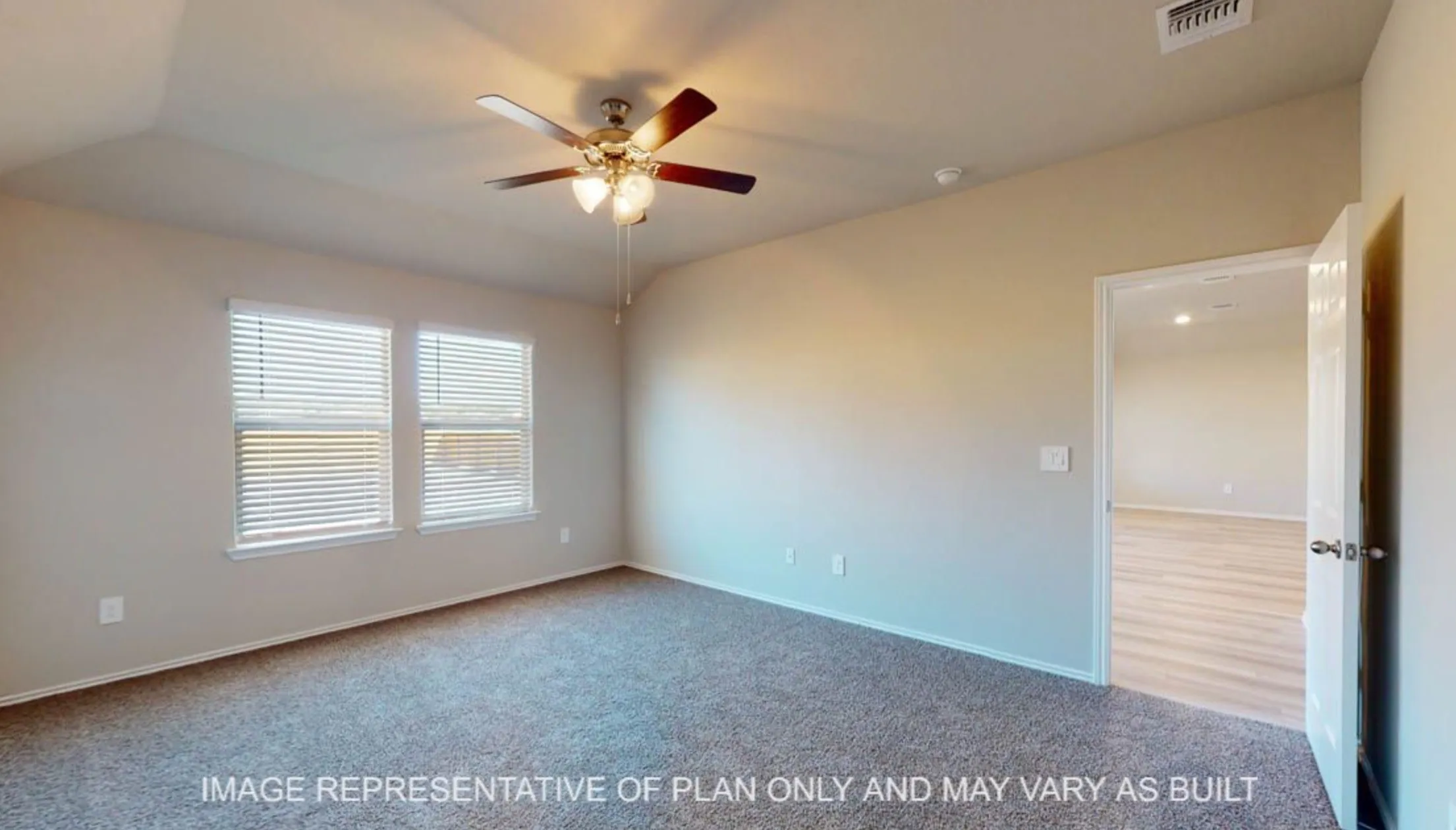 Vaulted ceiling, ceiling fan, two windows with blinds, light neutral wall paint, and textured carpet flooring