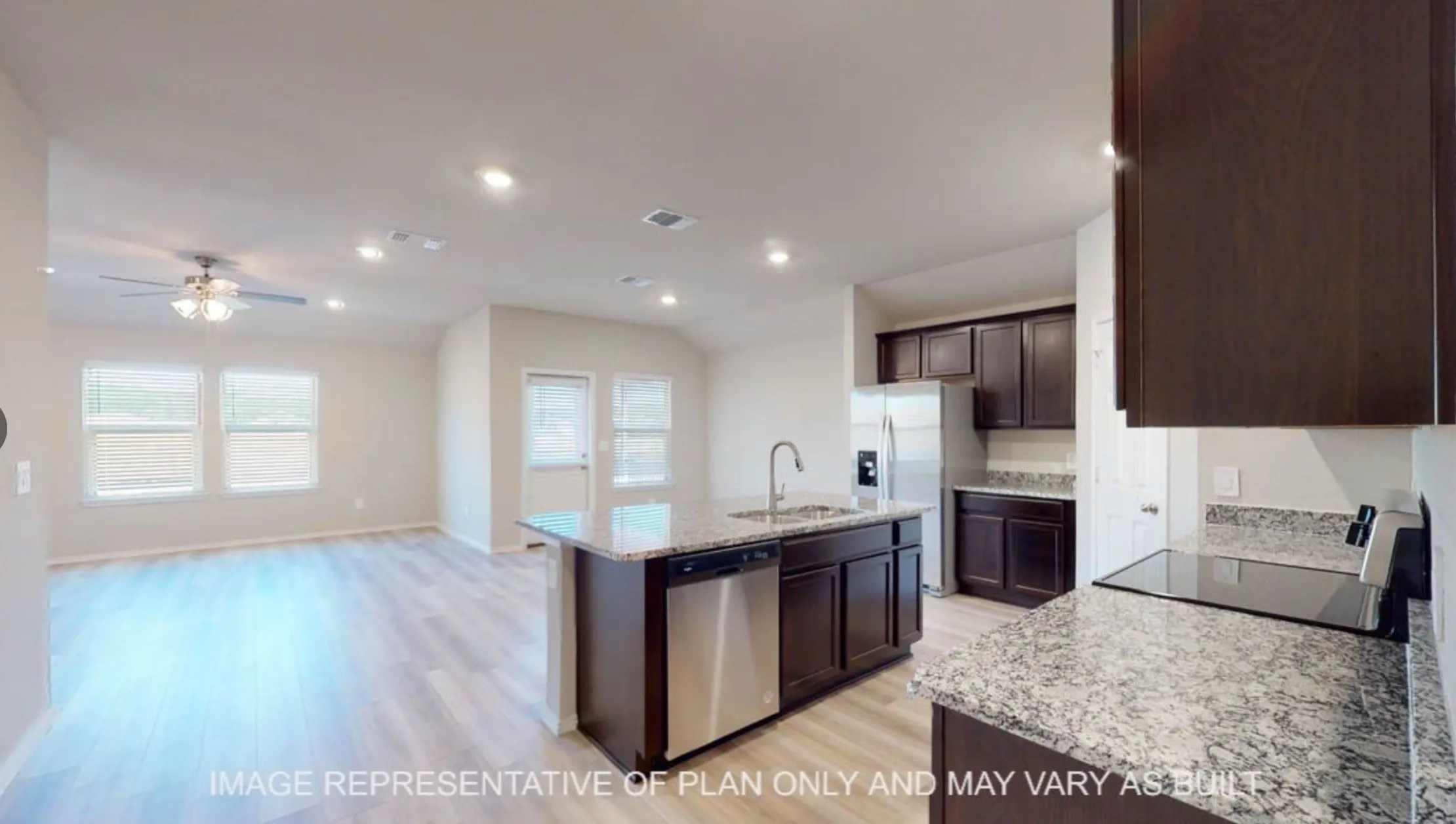 Open-concept living area with wood-finish flooring, a ceiling fan, and recessed lighting