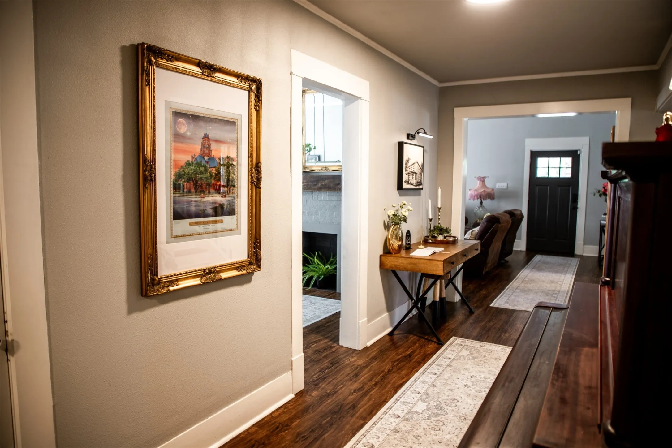 Wood-finish flooring throughout, bright white trim, and neutral wall tones