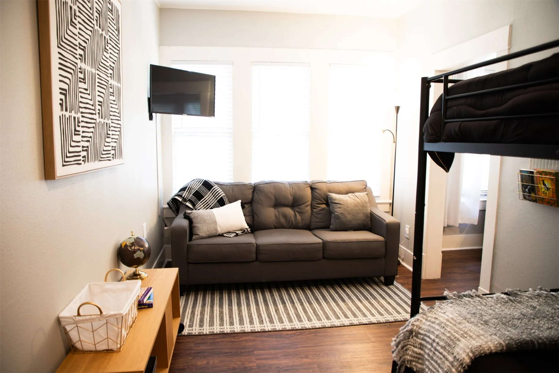 Wood-finish flooring, white trim, and light-colored walls