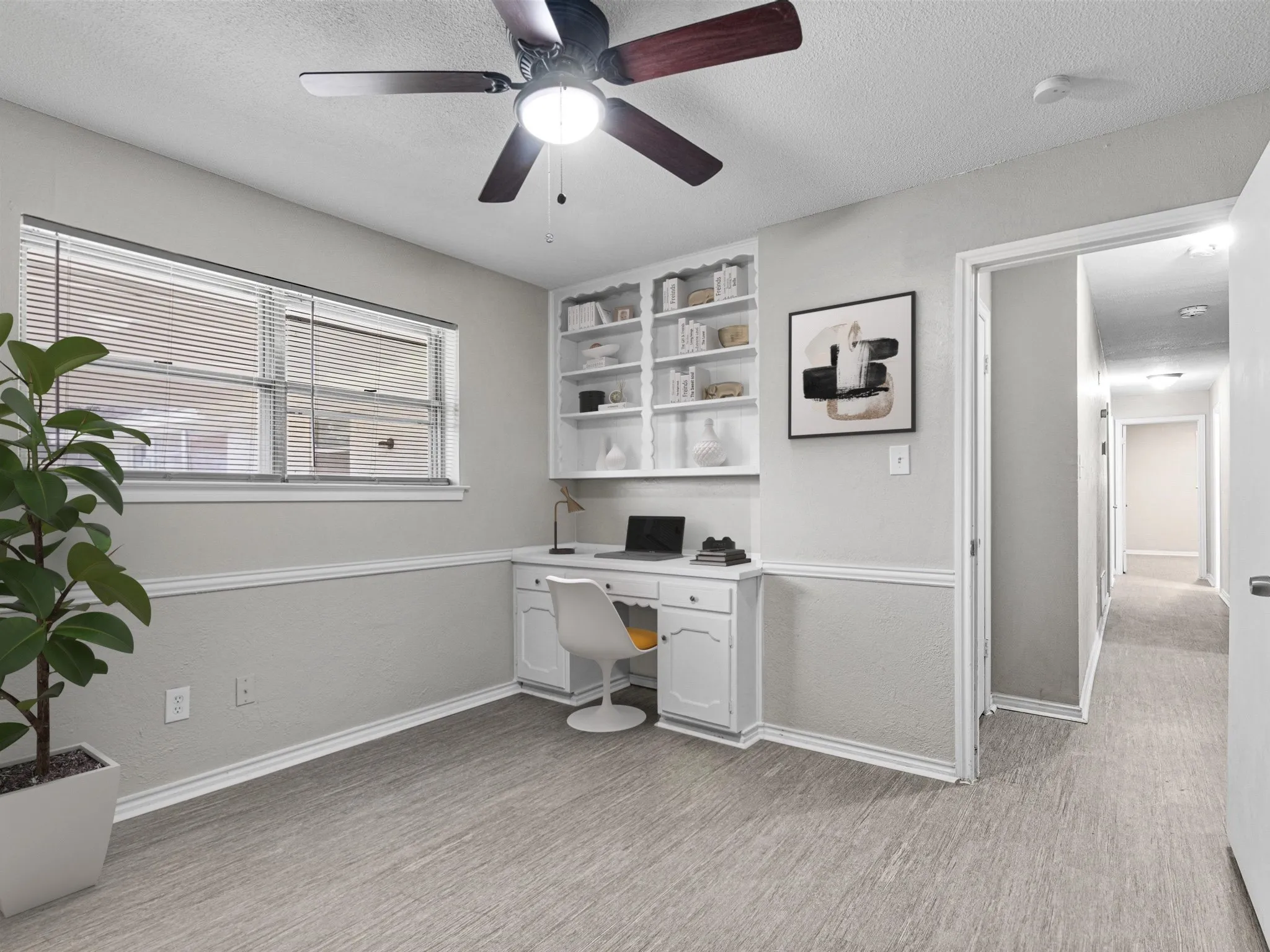 Ceiling fan with light, built-in desk, built-in shelving, windows with blinds, and wood-finish flooring