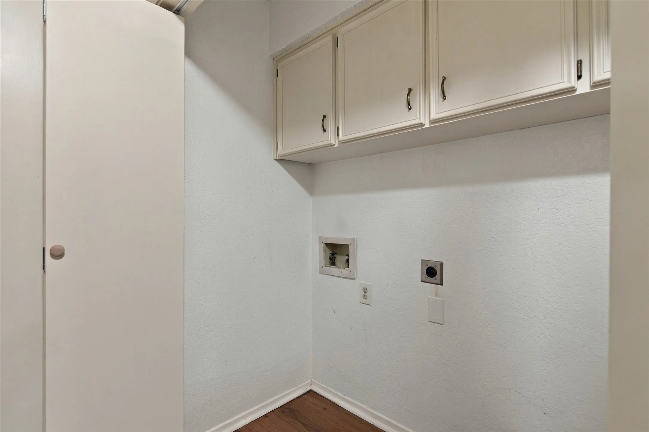 Hall laundry closet with built-in upper cabinets