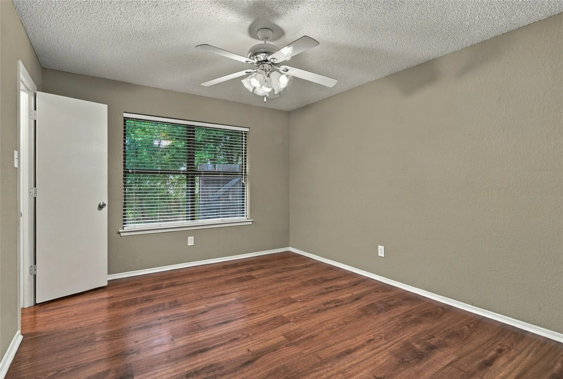 LVP flooring, ceiling fan with integrated lighting, and a window with horizontal blinds