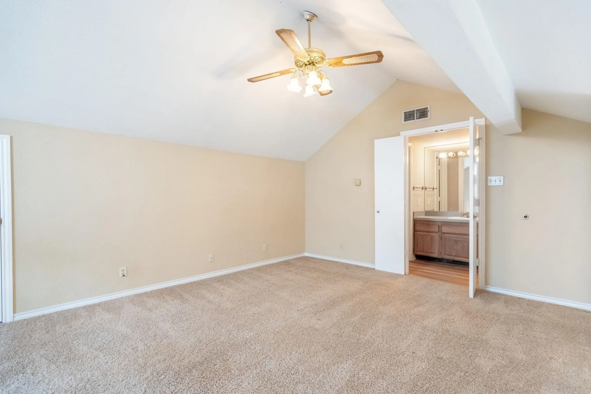 Vaulted ceiling featuring a ceiling fan with integrated lighting